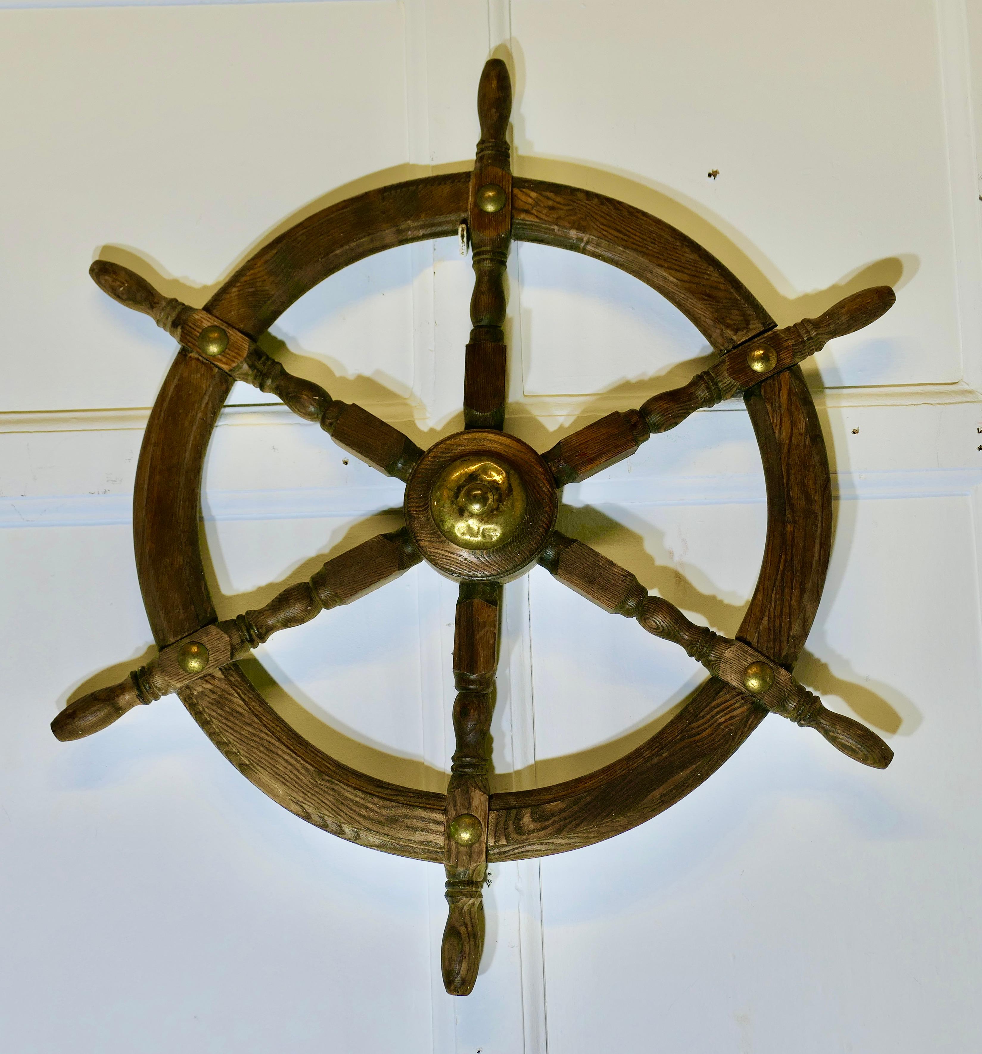 Early 20th Century Oak Ships Wheel

A wonderful and decorative piece, made in solid oak with turned spindles radiating out from the drum and highlighter with brass work
The Wheel is 28” in diameter and 3” thick
ZX265