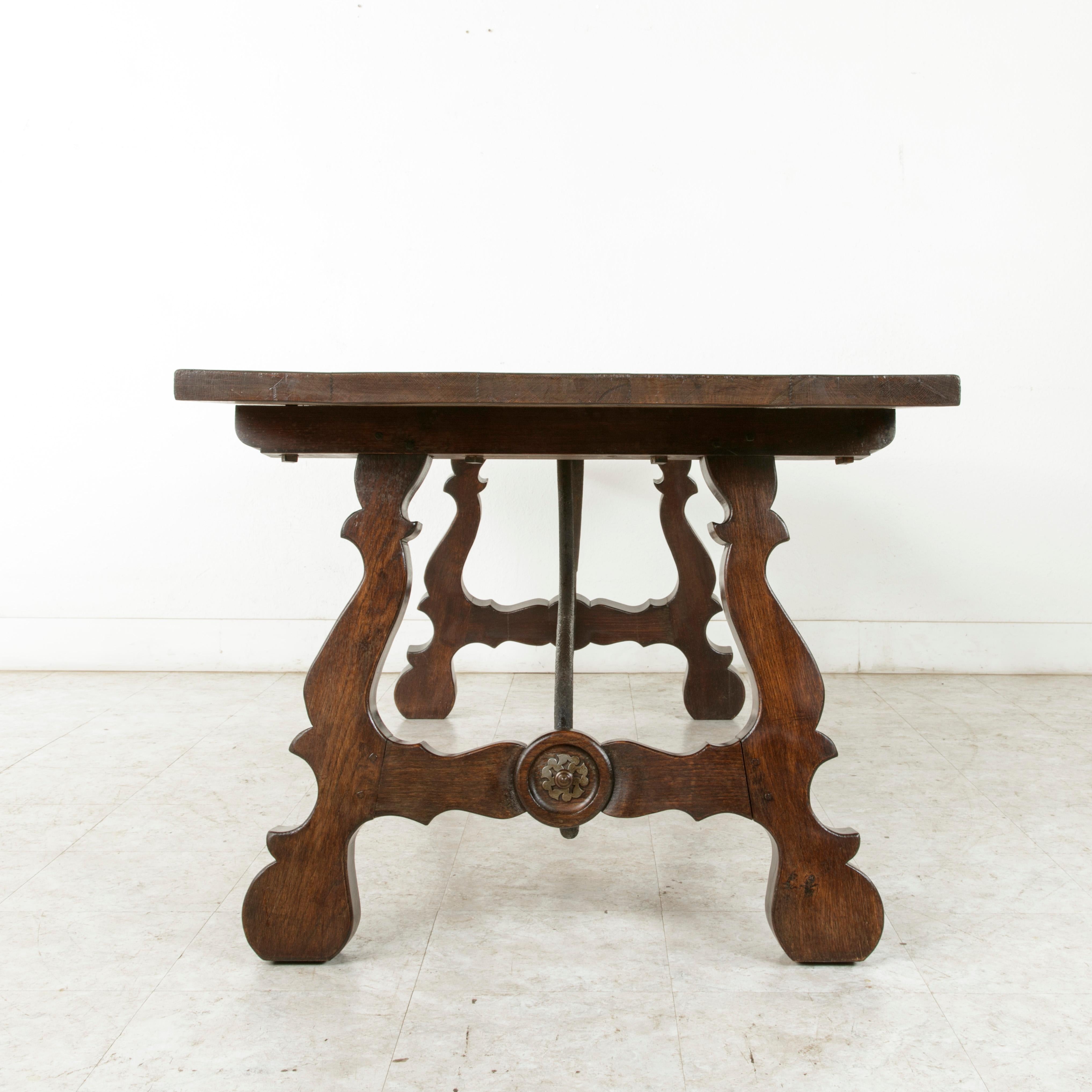 Early 20th Century Oak Spanish Renaissance Style Dining Table, Iron Stretcher In Good Condition In Fayetteville, AR