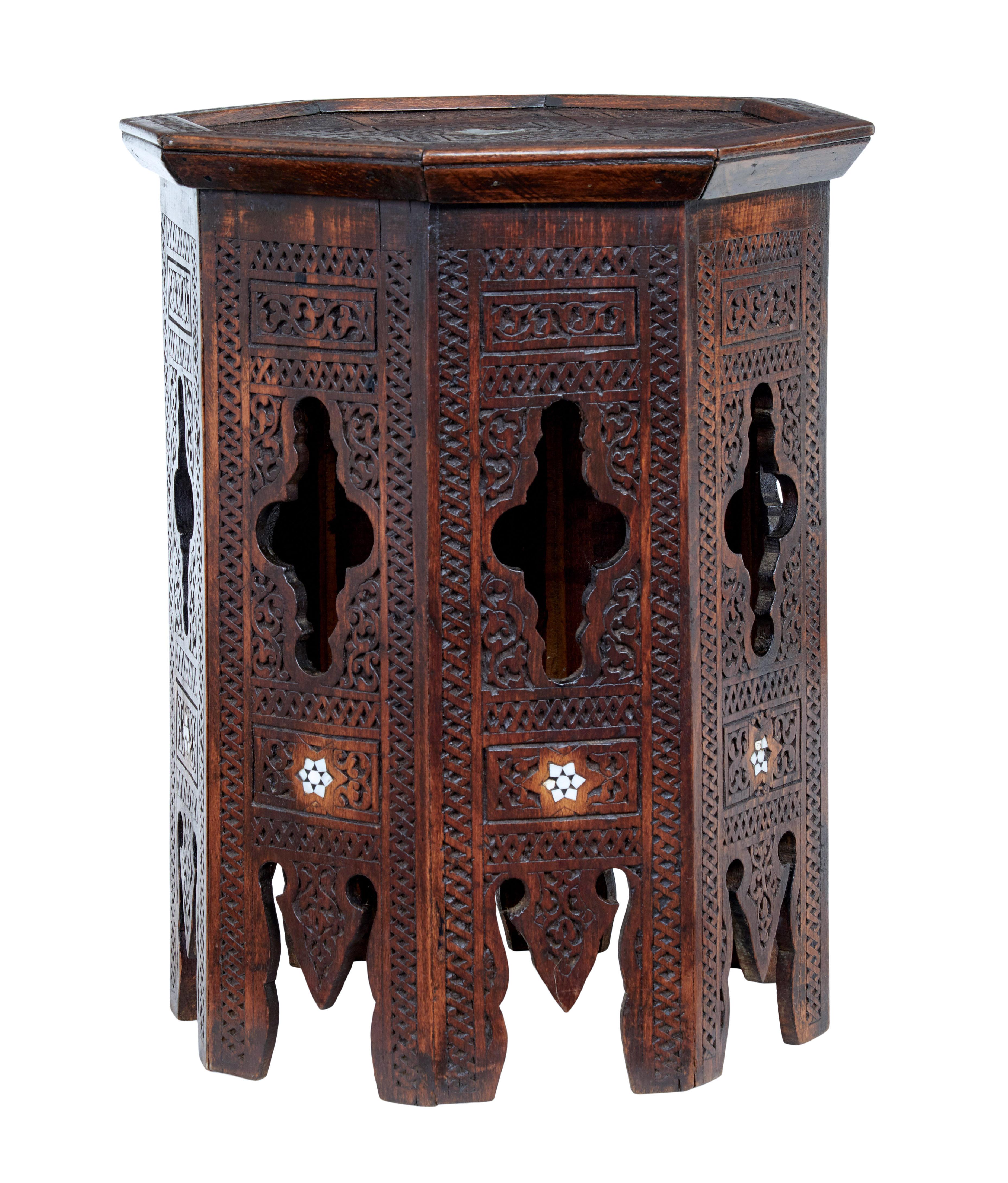 Early 20th century octagonal Moorish side table circa 1920.

Good quality hardwood side table.  Typical octagonal shaped top with carved border and mother of pearl insert.  Supported by an 8 sided carved base, with further mother of pearl