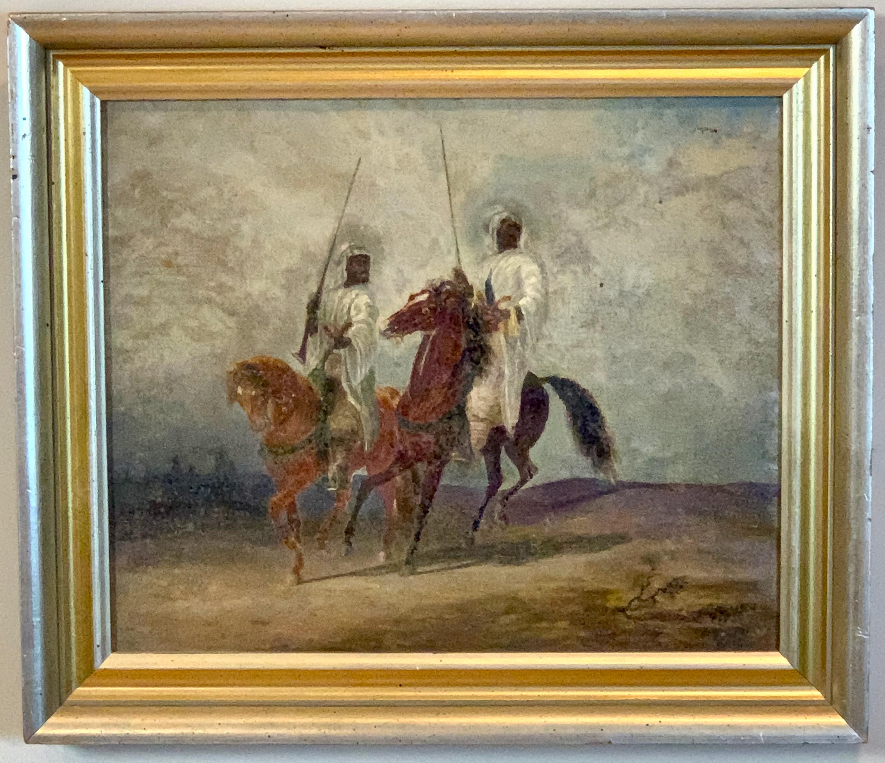 A small and charming early 20th century oil on canvas painting of Bedouin chieftains on horseback in a desert landscape.