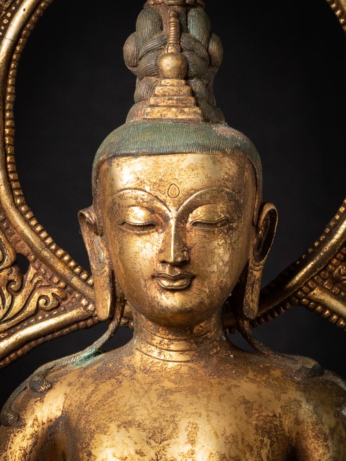 The Old bronze Nepali Bodhisattva Padmapani Lokeshvara is a truly exceptional and sacred artifact originating from Nepal. Crafted from bronze, this Bodhisattva statue stands at an impressive height of 86 cm and measures 31.5 cm in width and 27.5 cm