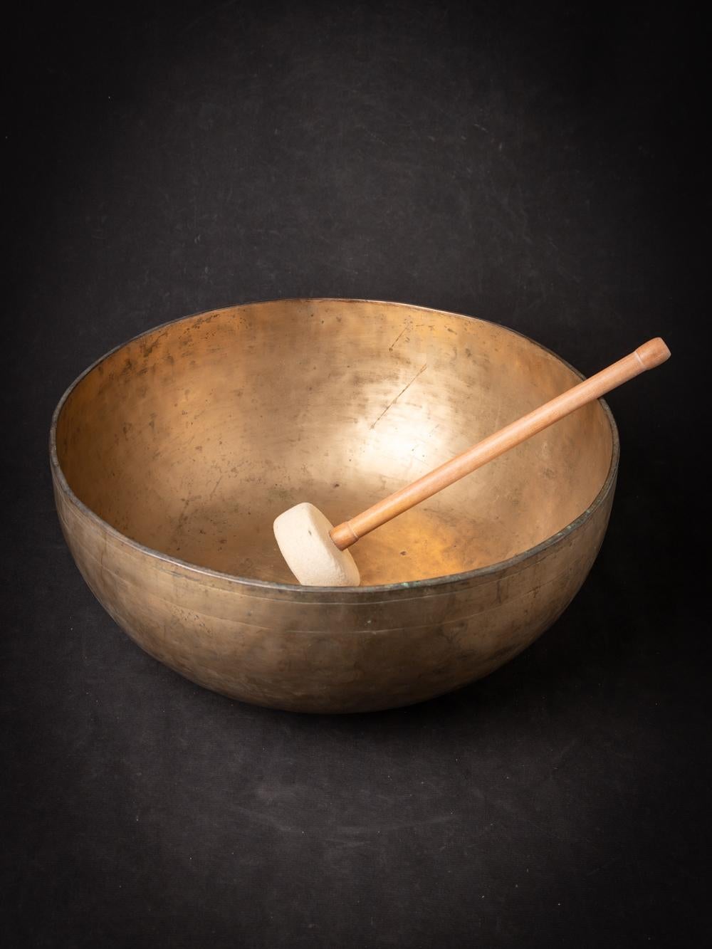 The Old bronze Nepali Singing Bowl from Nepal is a testament to the skilled craftsmanship and musical tradition of the region. Created from bronze, this singing bowl stands at a height of 18.7 cm and has a diameter of 43.2 cm. Crafted with a focus