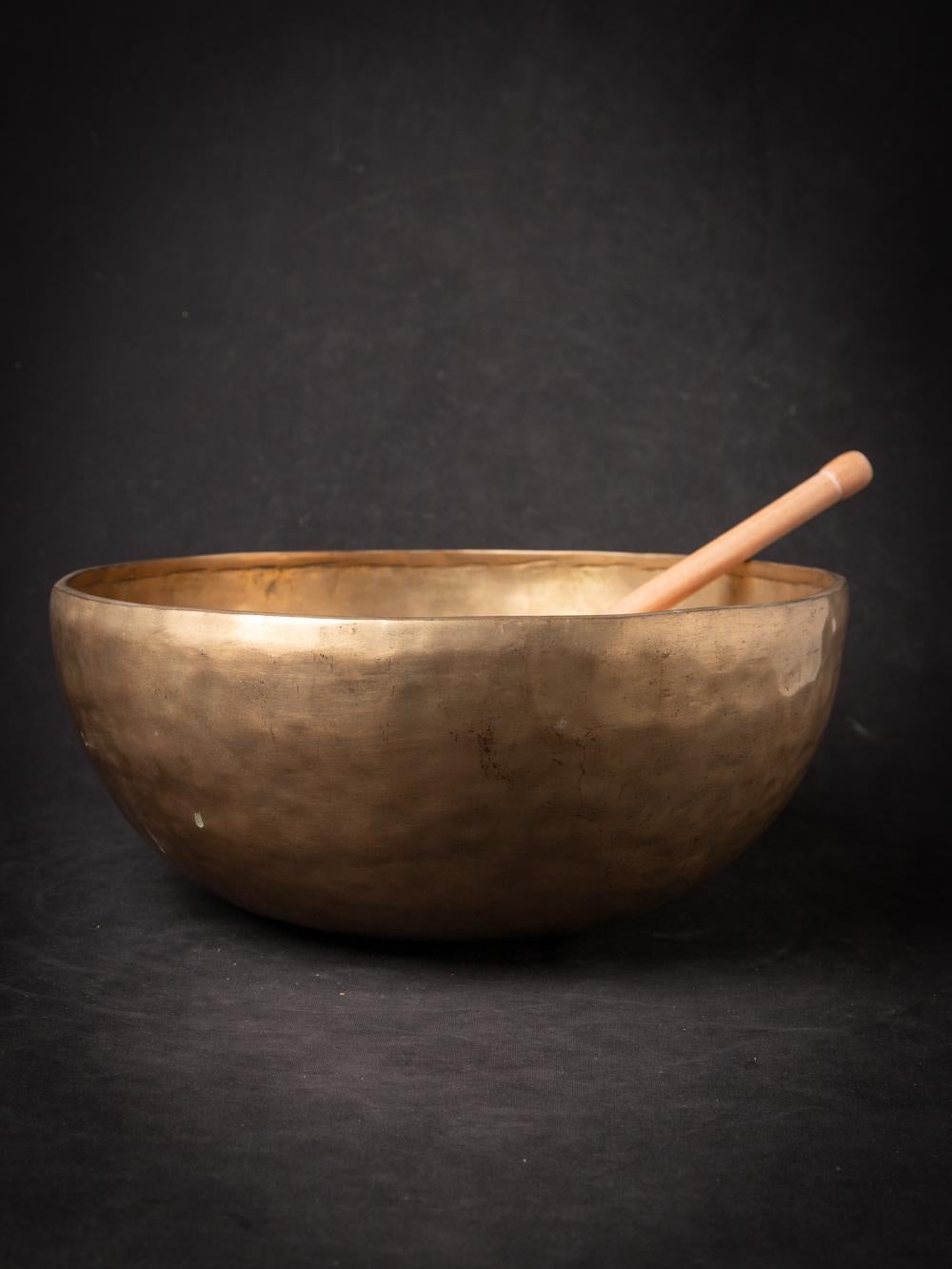 The Old bronze Nepali Singing Bowl from Nepal is a testament to the skilled craftsmanship and musical tradition of the region. Created from bronze, this singing bowl stands at a height of 15.6 cm and has a diameter of 36.5 cm. Crafted with a focus
