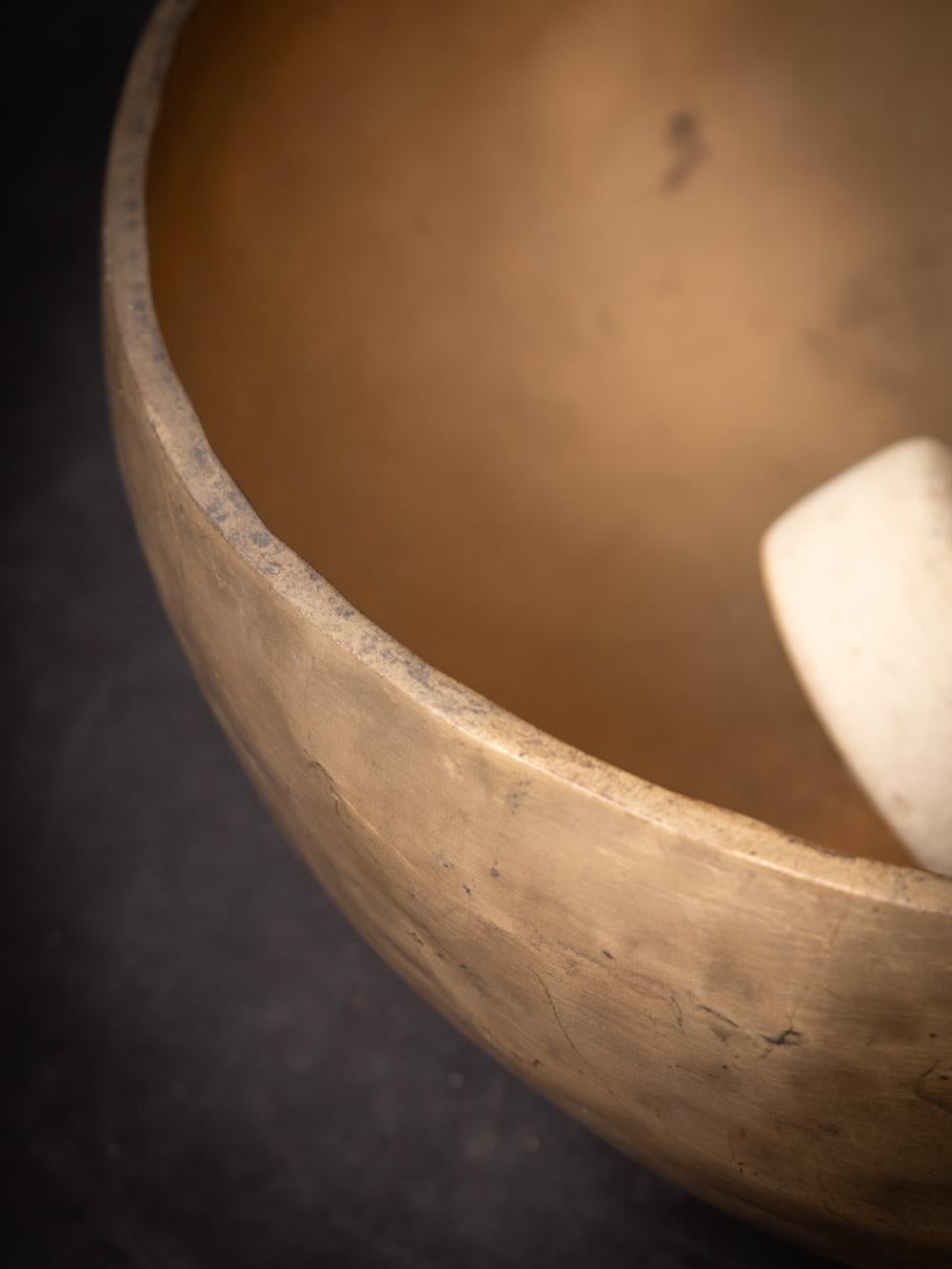 The Old bronze Nepali Singing Bowl from Nepal is a testament to the skilled craftsmanship and musical tradition of the region. Created from bronze, this singing bowl stands at a height of 16 cm and has a diameter of 36 cm. Crafted with a focus on