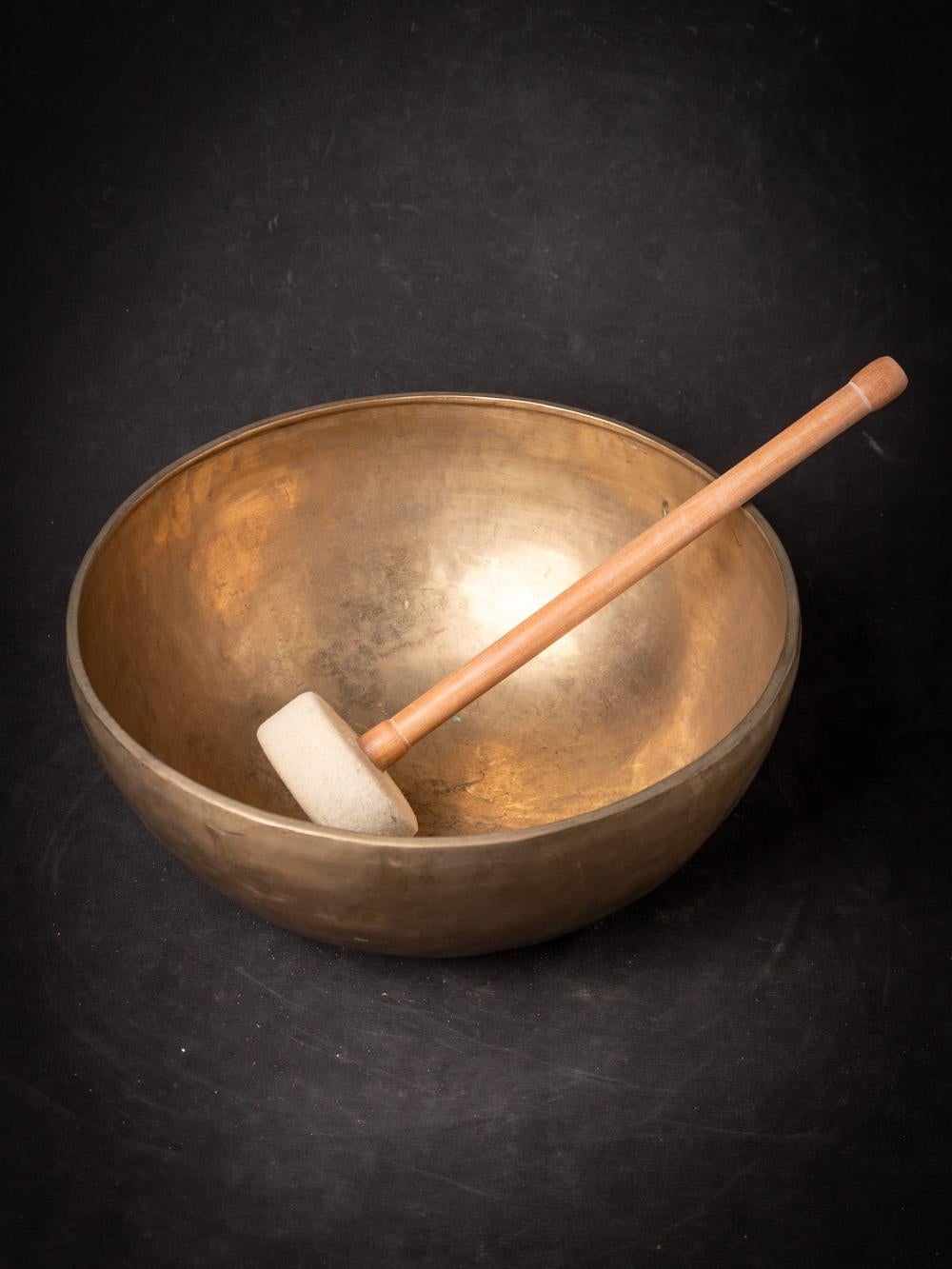 The Old bronze Nepali Singing Bowl from Nepal is a testament to the skilled craftsmanship and musical tradition of the region. Created from bronze, this singing bowl stands at a height of 14 cm and has a diameter of 33 cm. Crafted with a focus on