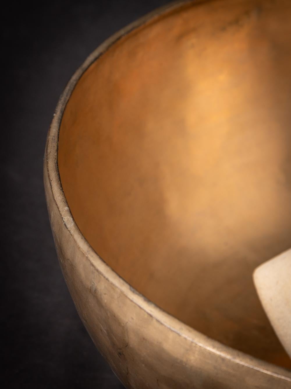 The Old bronze Nepali Singing Bowl from Nepal is a testament to the skilled craftsmanship and musical tradition of the region. Created from bronze, this singing bowl stands at a height of 17 cm and has a diameter of 41 cm. Crafted with a focus on
