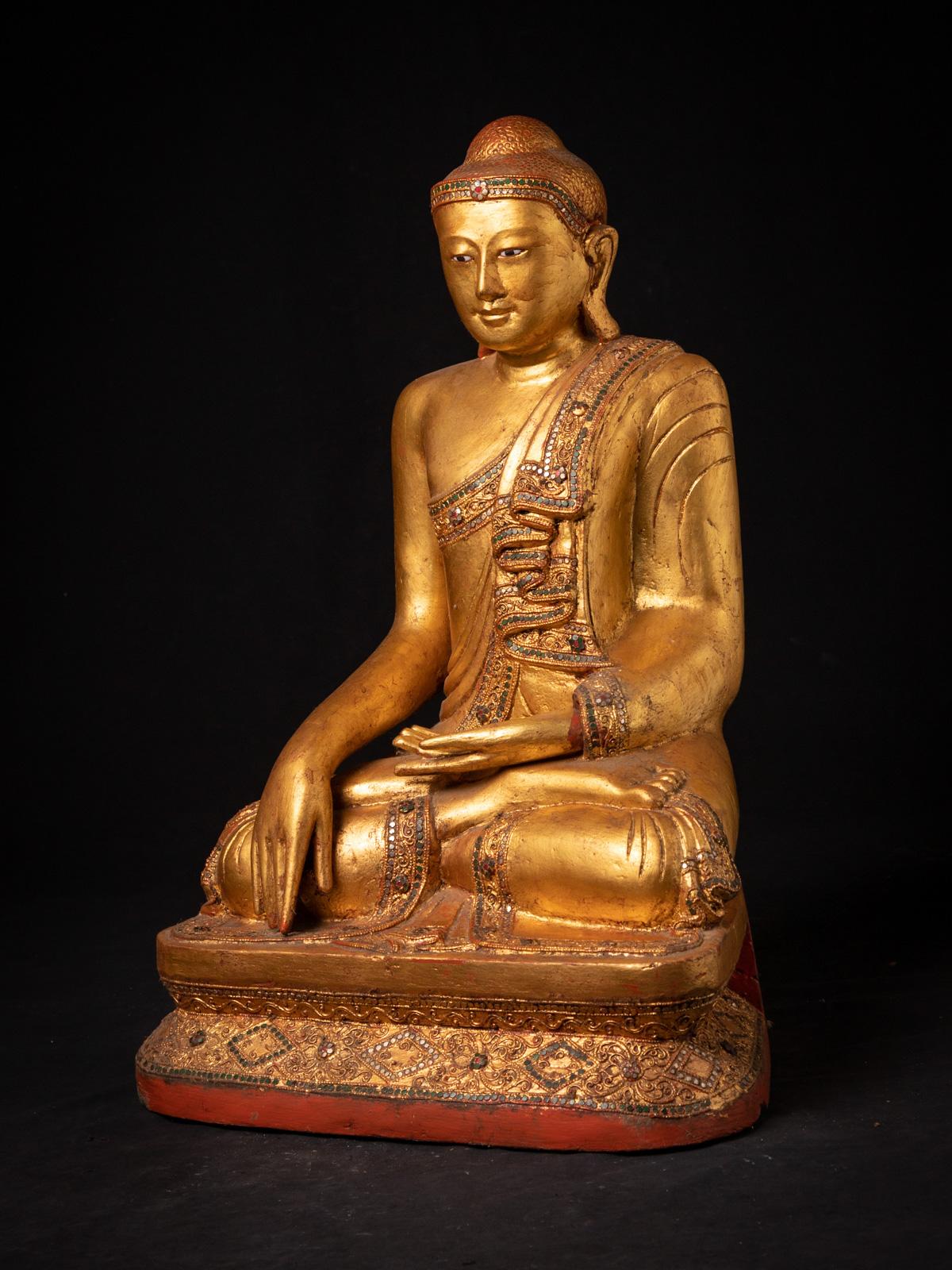 The old wooden Burmese Mandalay Buddha statue is a magnificent representation of artistic and spiritual craftsmanship. Crafted from wood, this statue stands 66 cm tall, with dimensions of 44.5 cm in width and 34.5 cm in depth. Its impressive size