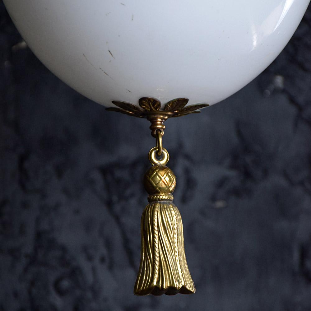 Early 20th century opaline and brass tassel light.

An untouched example of an early 20th century opaline glass and brass tassel detailed light shade. 

Size in inches: H 18” x W 12” x D 12”
Units: 1
Period: 1920 - 1930
Material: Glass &