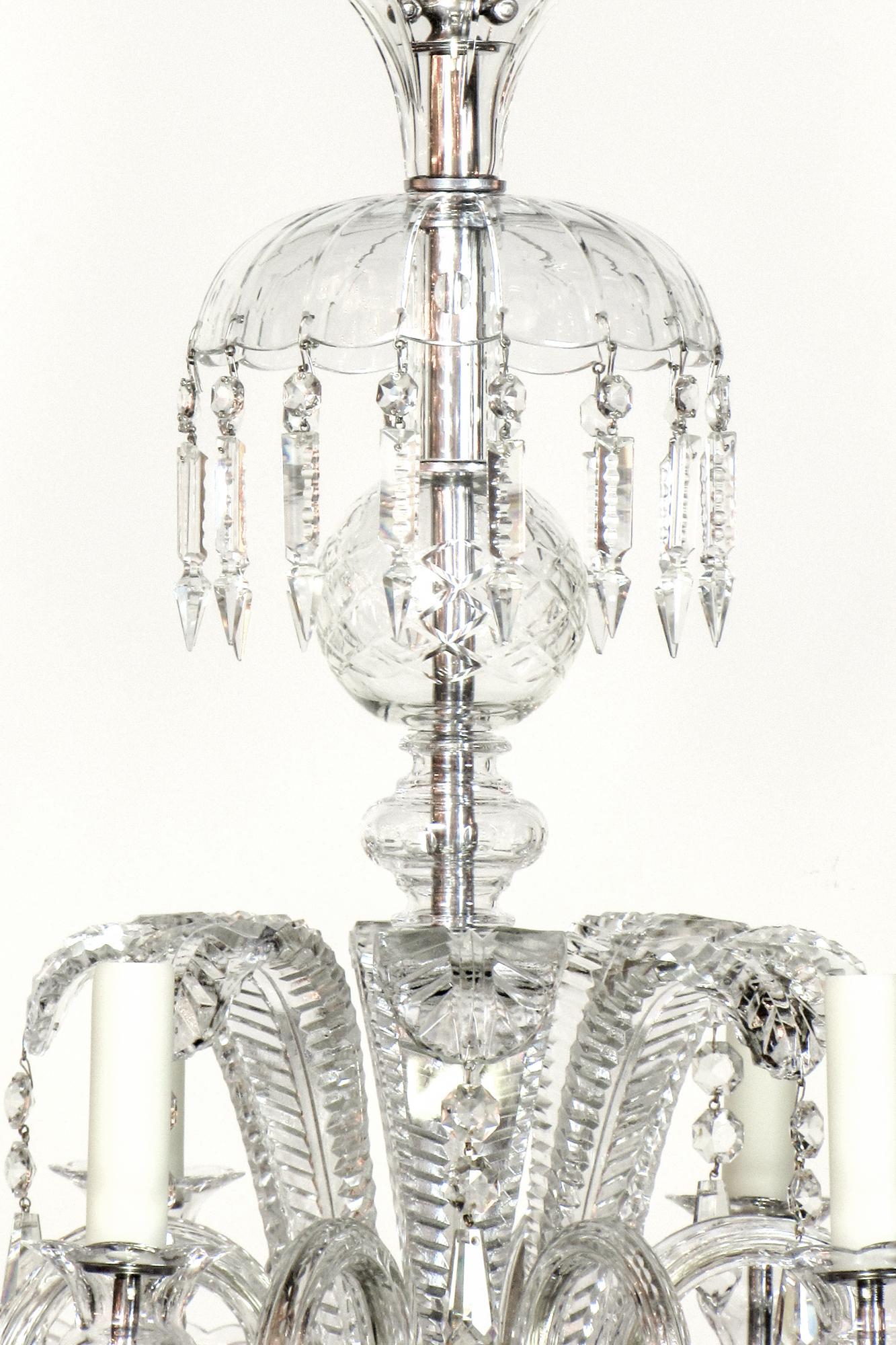 Early 20th century ostrich feather crystal chandelier.  Eight arm crystal chandelier with crystal ostrich feather plumes. Top crown is hung with cut spear crystals.  Stem pieces are cut clear crystal.  Ostrich feather shaped crystals add a decadence
