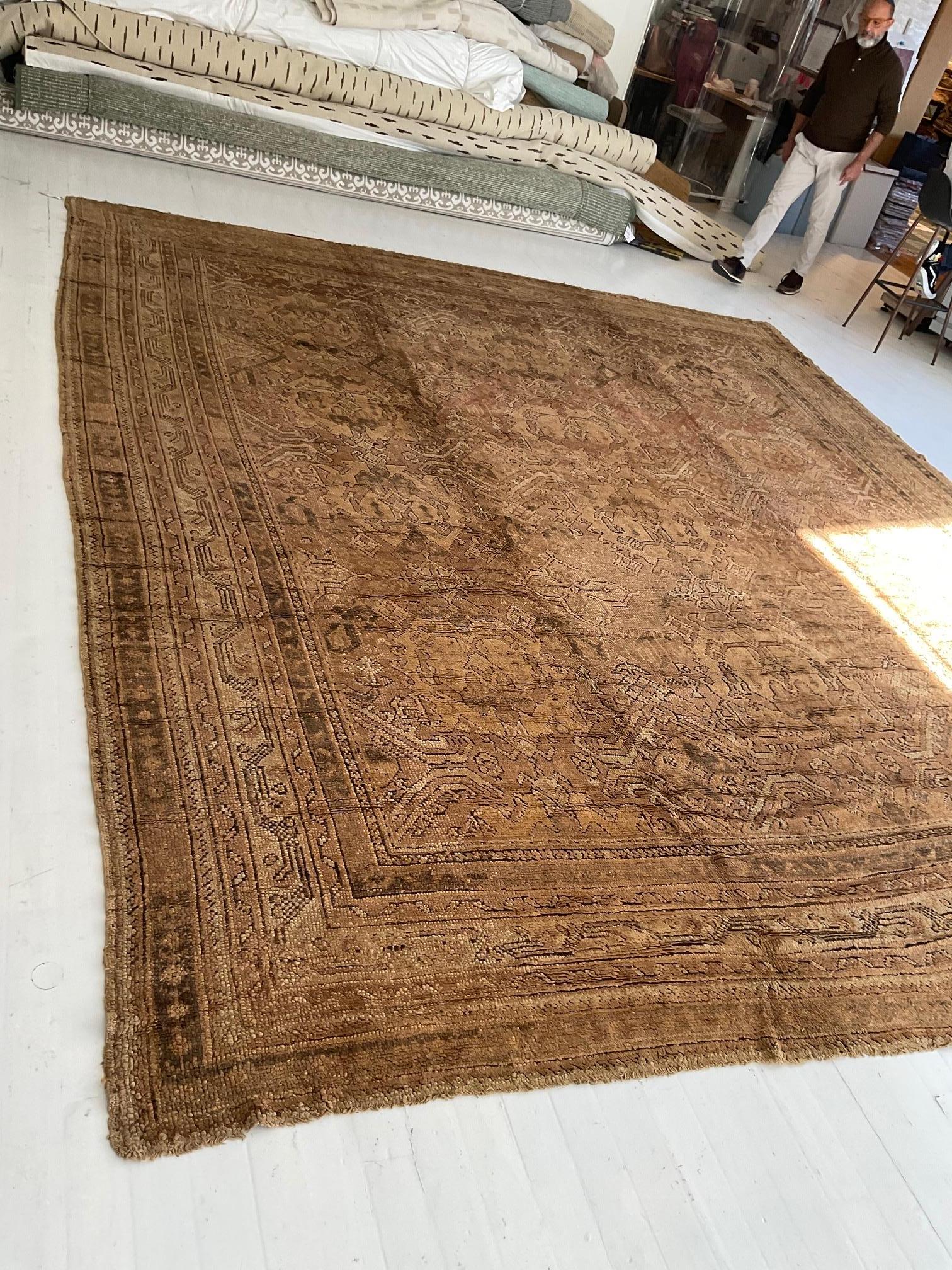 Early 20th century oushak brown handmade wool rug
Size: 12'6