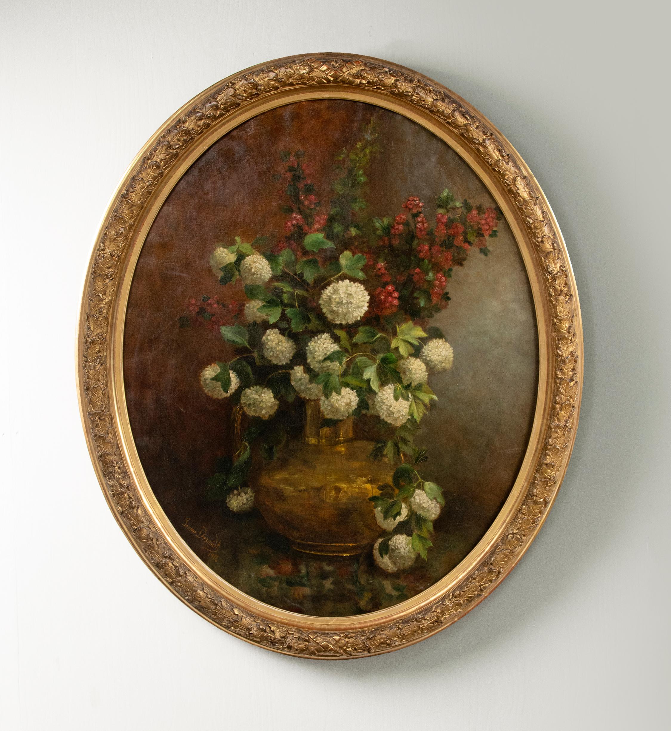A refined oil painting on canvas of a flower still life. Depicting white Viburnum flowers in a copper pot. The painting is signed lower left by the Belgian Jeanne Desmidt, a female artist. And dated 1916. The painting has the original frame. It is