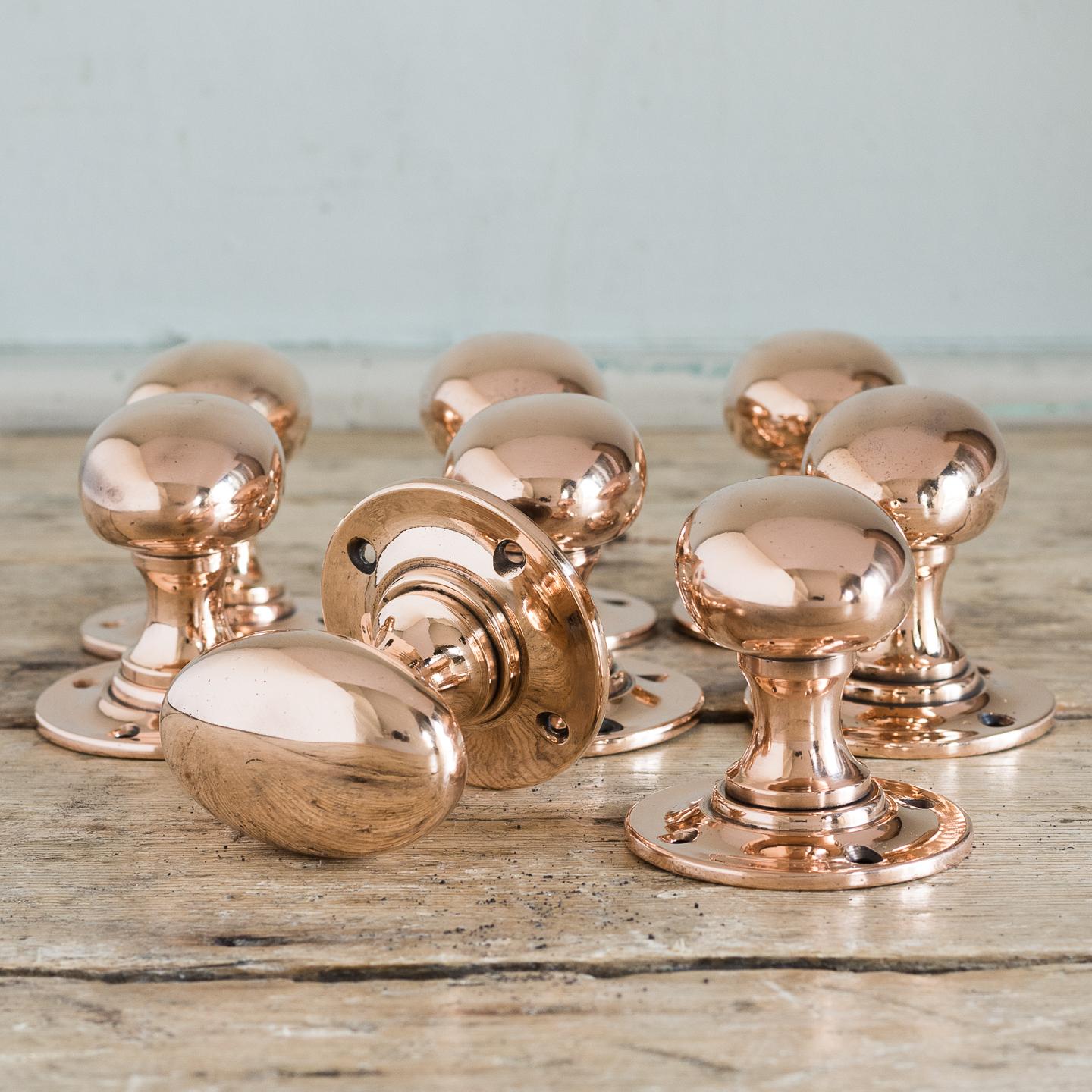 Large early 20th century oval rose brass door knobs, circa 1920. Four pairs available.