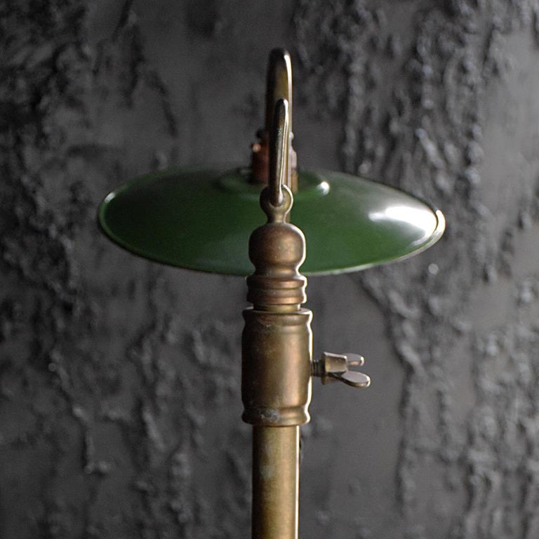 Early 20th century oversized brass articulated lamp

We are proud to offer one of the largest English brass articulated lamps we have been lucky enough to uncover. With a solid brass base, elegant “S” shaped adjustable neck with enamel green shade
