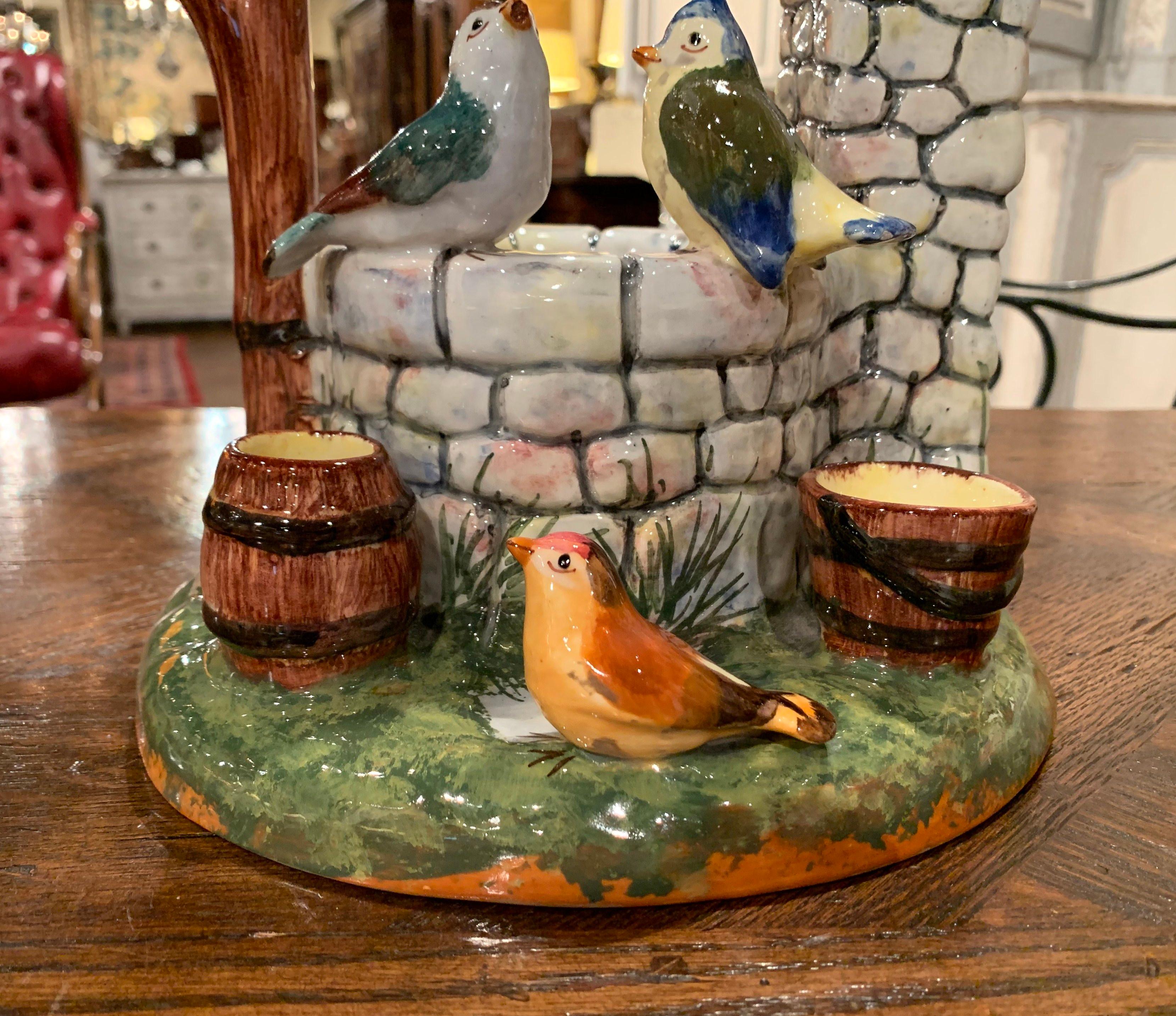 Add color to a tabletop, mantel or shelf with this colorful, antique Majolica well sculpture. The intricate barbotine piece was sculpted in France, circa 1910, and features a well with a bucket and a barrel surrounded by six birds. The hand painted,
