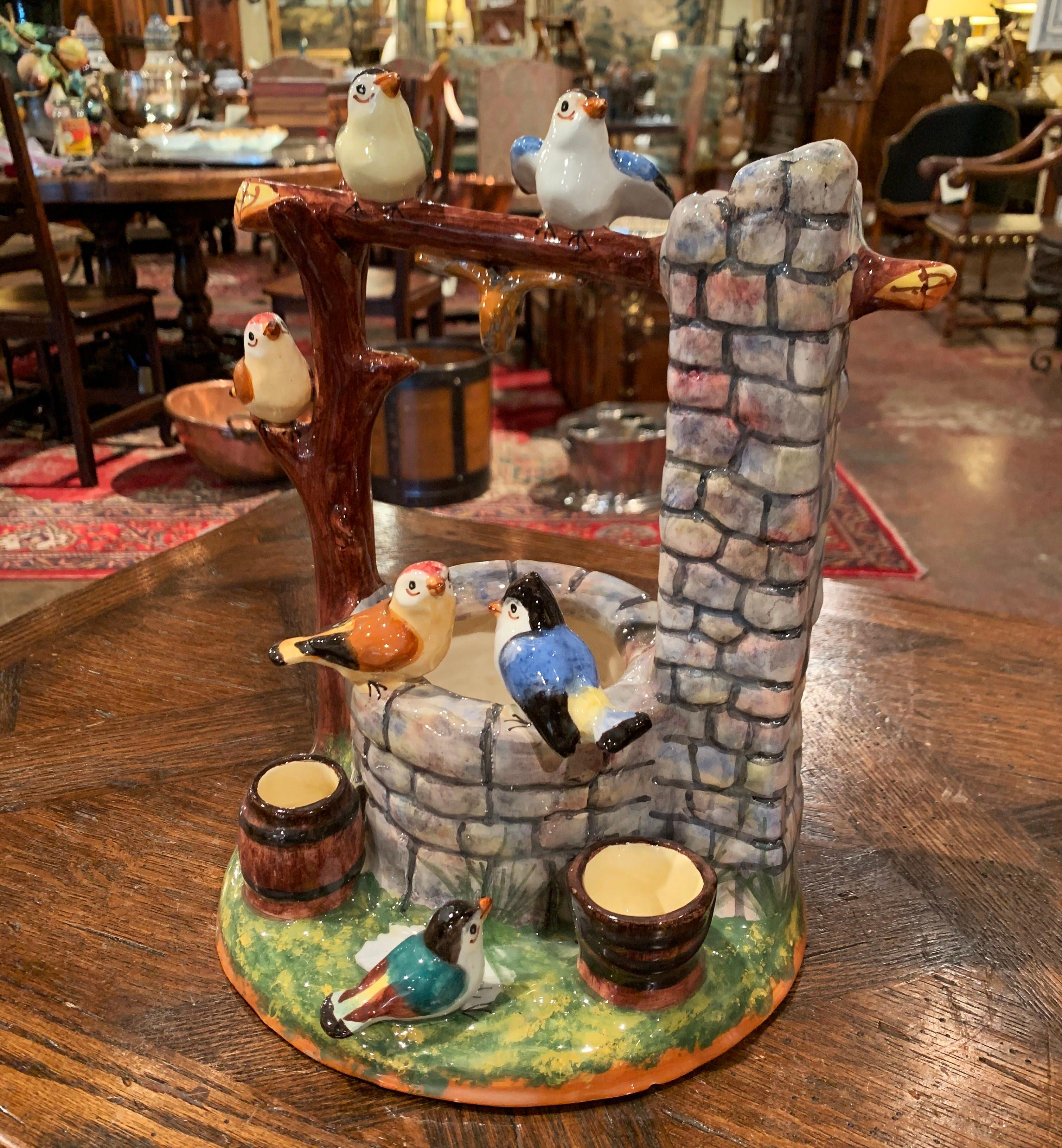 Add color to a tabletop, mantel or shelf with this colorful, antique Majolica well sculpture. The intricate barbotine piece was sculpted in France, circa 1920, and features a well with a bucket and a barrel surrounded by six birds. The hand painted,