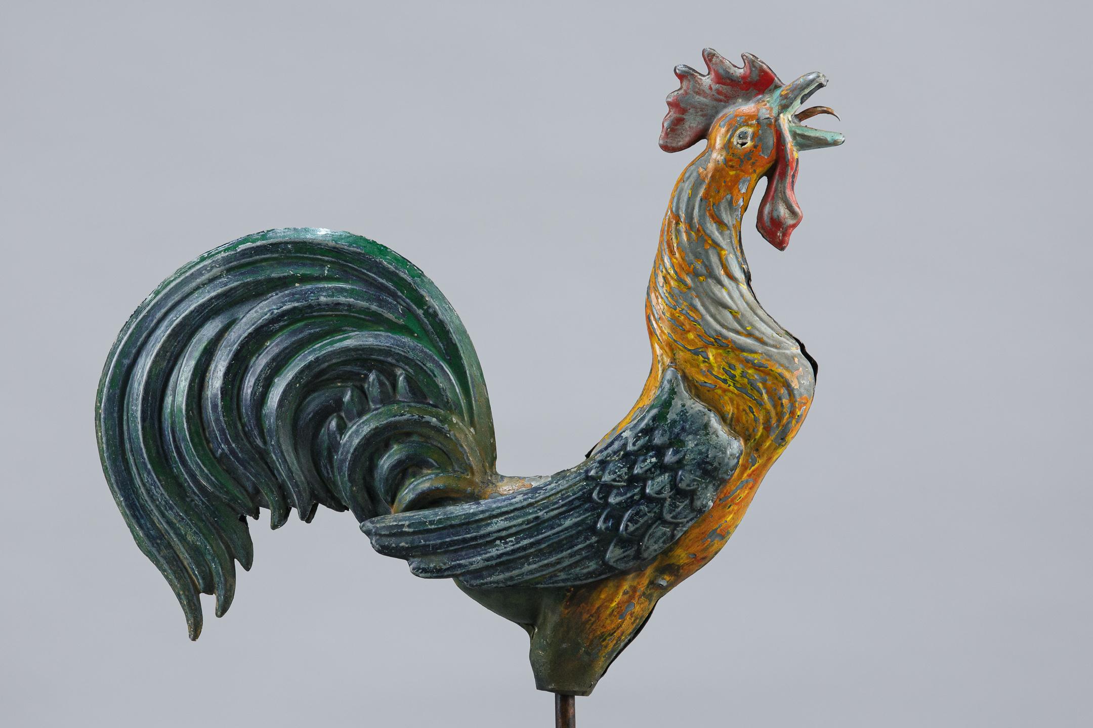 Early 20th century copper cockerel weathervane, original painted finish. mounted to a later stand, some minor damage including a small pellet hole underneath the eye. France Circa 1920. Measurement includes stand.