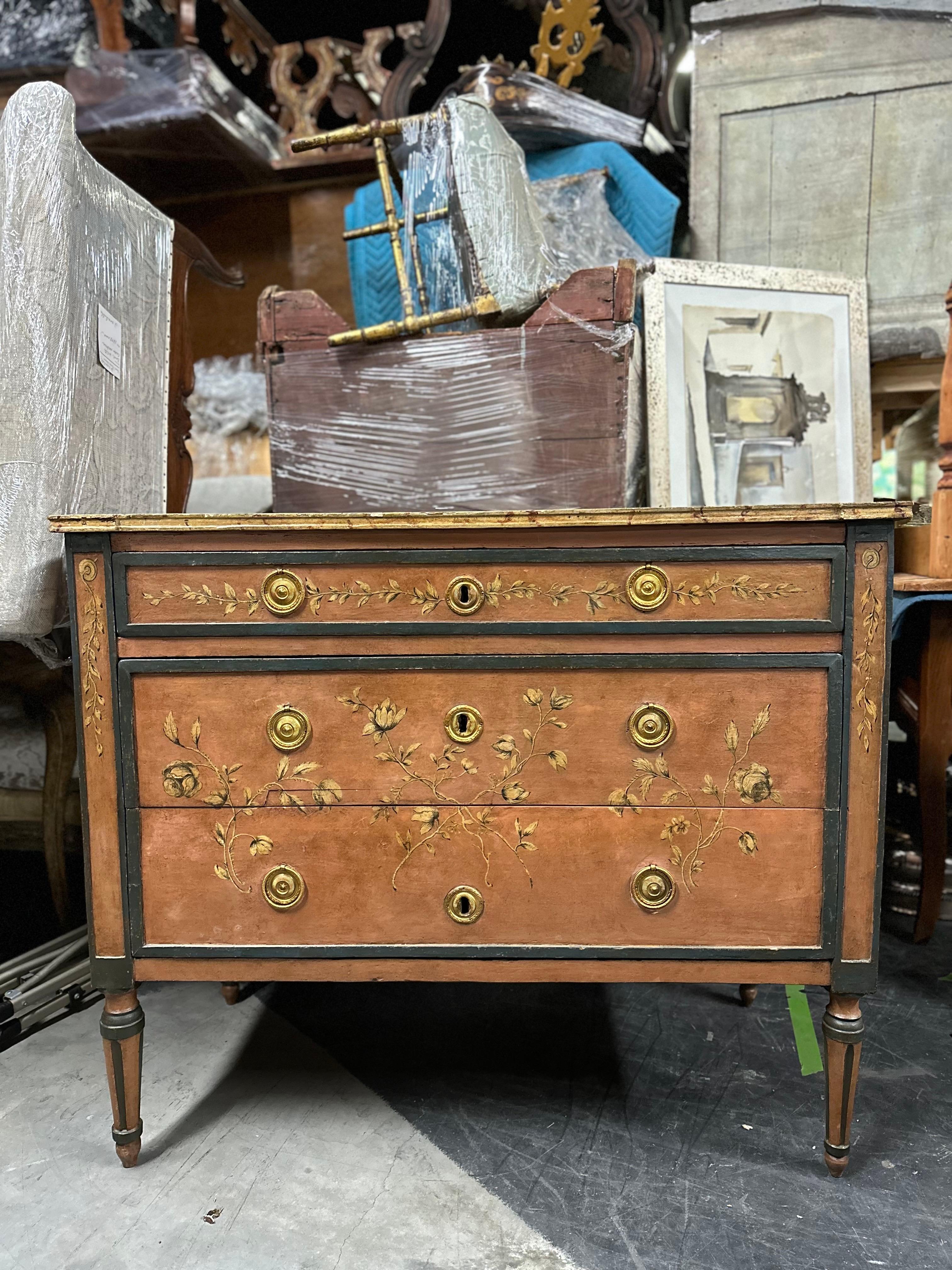 This Early 20th Century Painted Italian Neoclassical Style Three-Drawer Commode is a true testament to the enduring beauty of Neoclassical design. Crafted with meticulous attention to detail, it boasts a graceful and timeless elegance. The turned