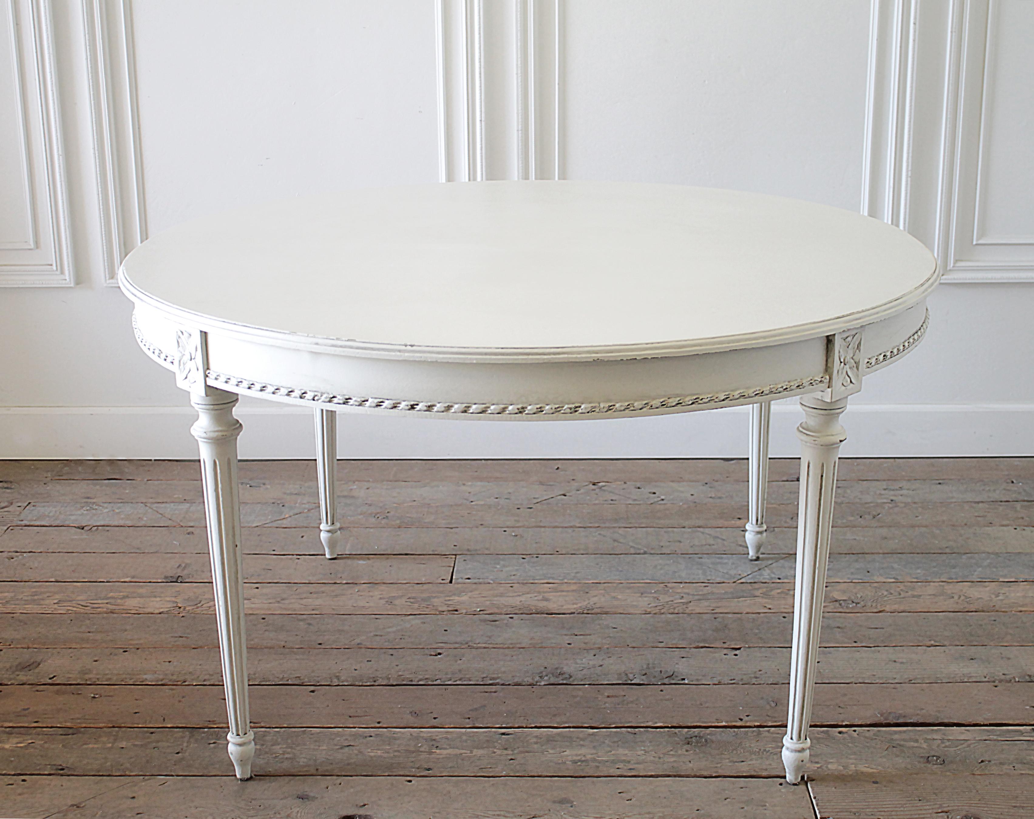 Early 20th century painted round Louis XVI style dining table
Painted in our oyster white finish, with subtle distressed edges, and soft antique glazed patina. Color is white, with a light greyish hue from the glaze, overall table is white.
Legs