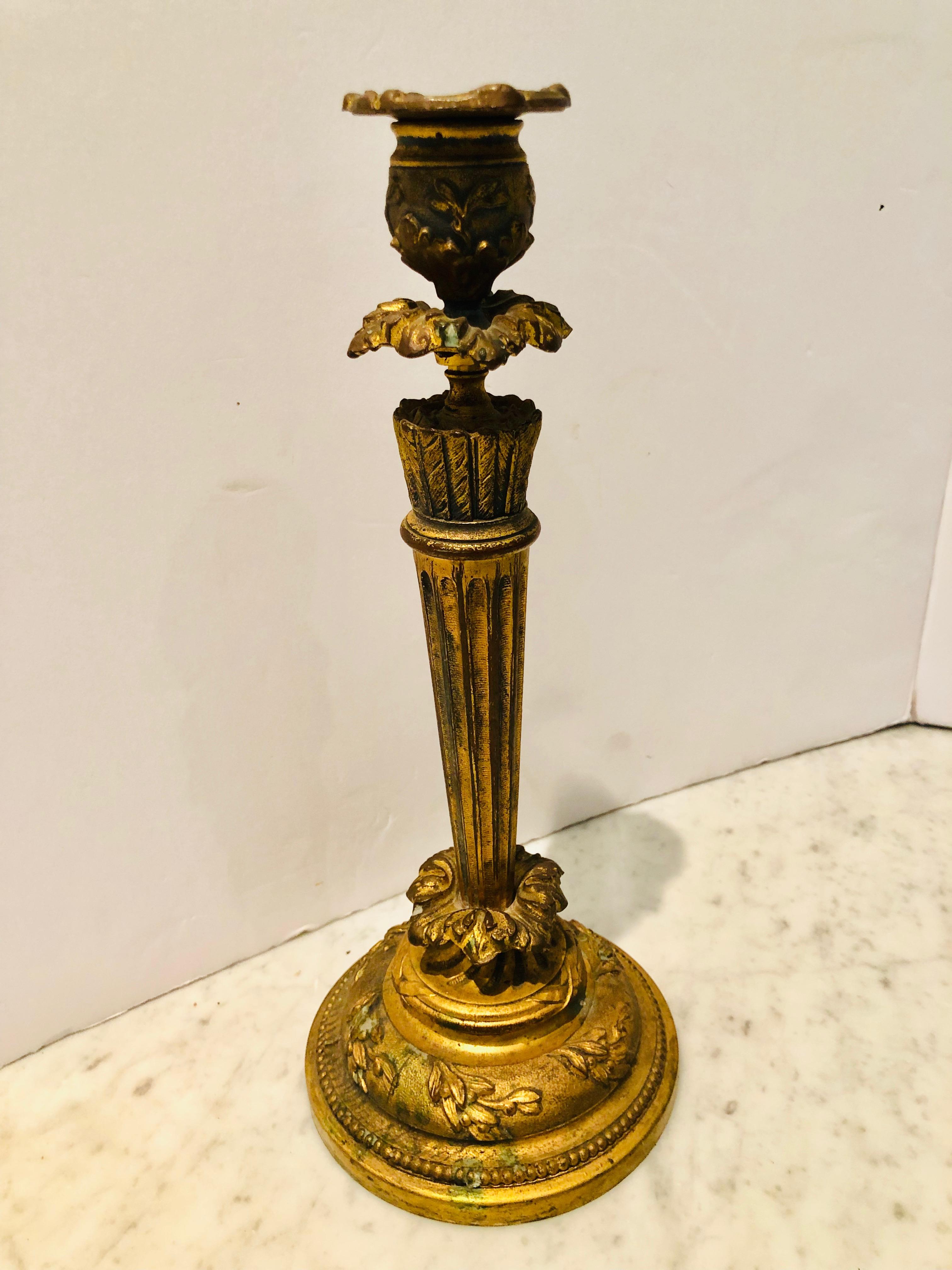 Lovely pic of antique candlesticks in solid bronze. Floral decoration and beading around the base and top. Bobeche is removable for ease of cleaning.