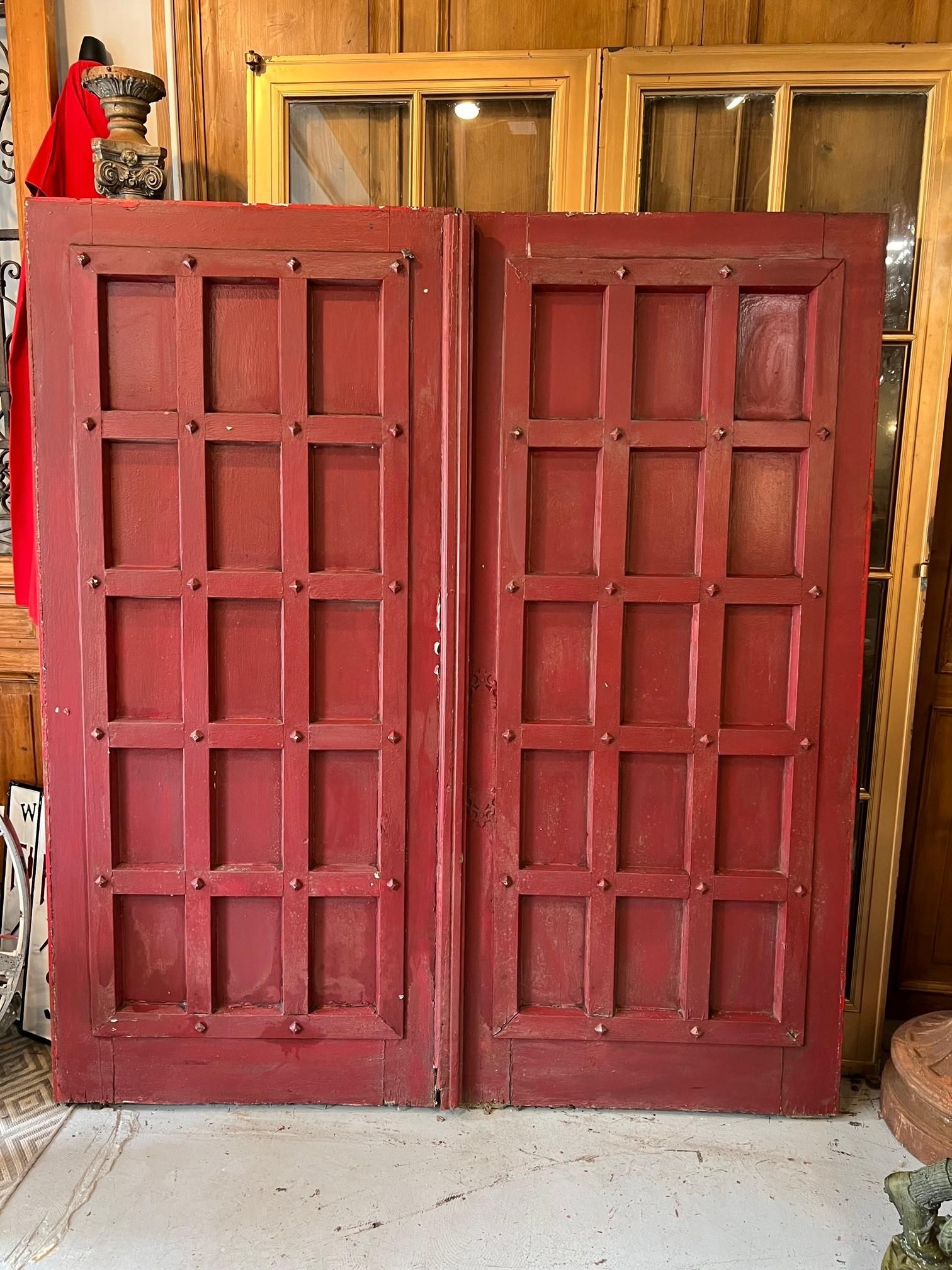 Early 20th century pair of antique doors with deep panels, a great look. This is a nice pair of doors that would look great sliding on a track between two rooms. Salvaged from an English Tudor in western PA. the doors due have some damage shown in