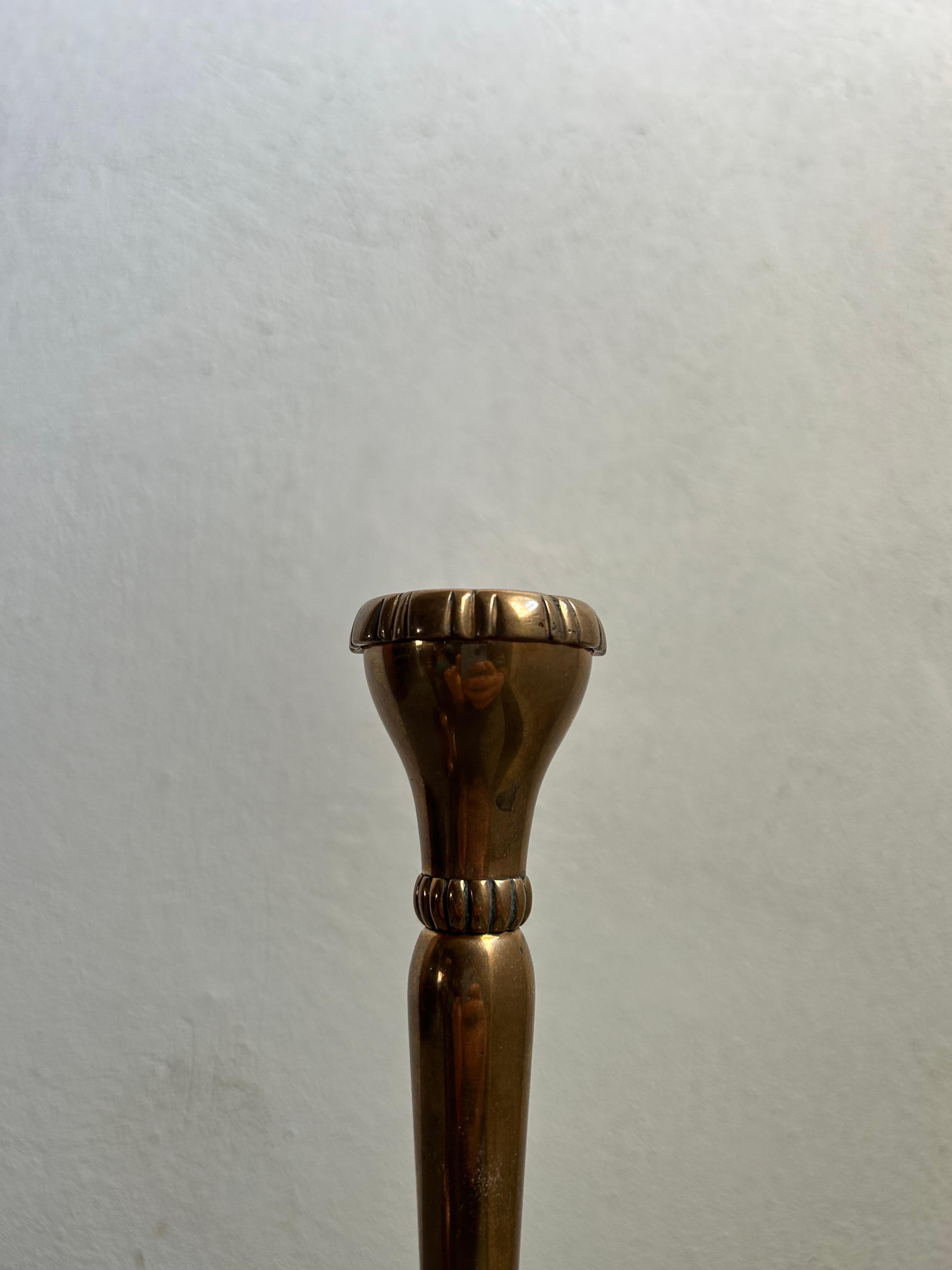 A rare and highly collectible pair of Danish Arts and Crafts candlesticks, Model B12, designed by Mogens Ballin in the early 1900s. Crafted in solid bronze, these candlesticks exemplify the refined craftsmanship and elegant simplicity characteristic