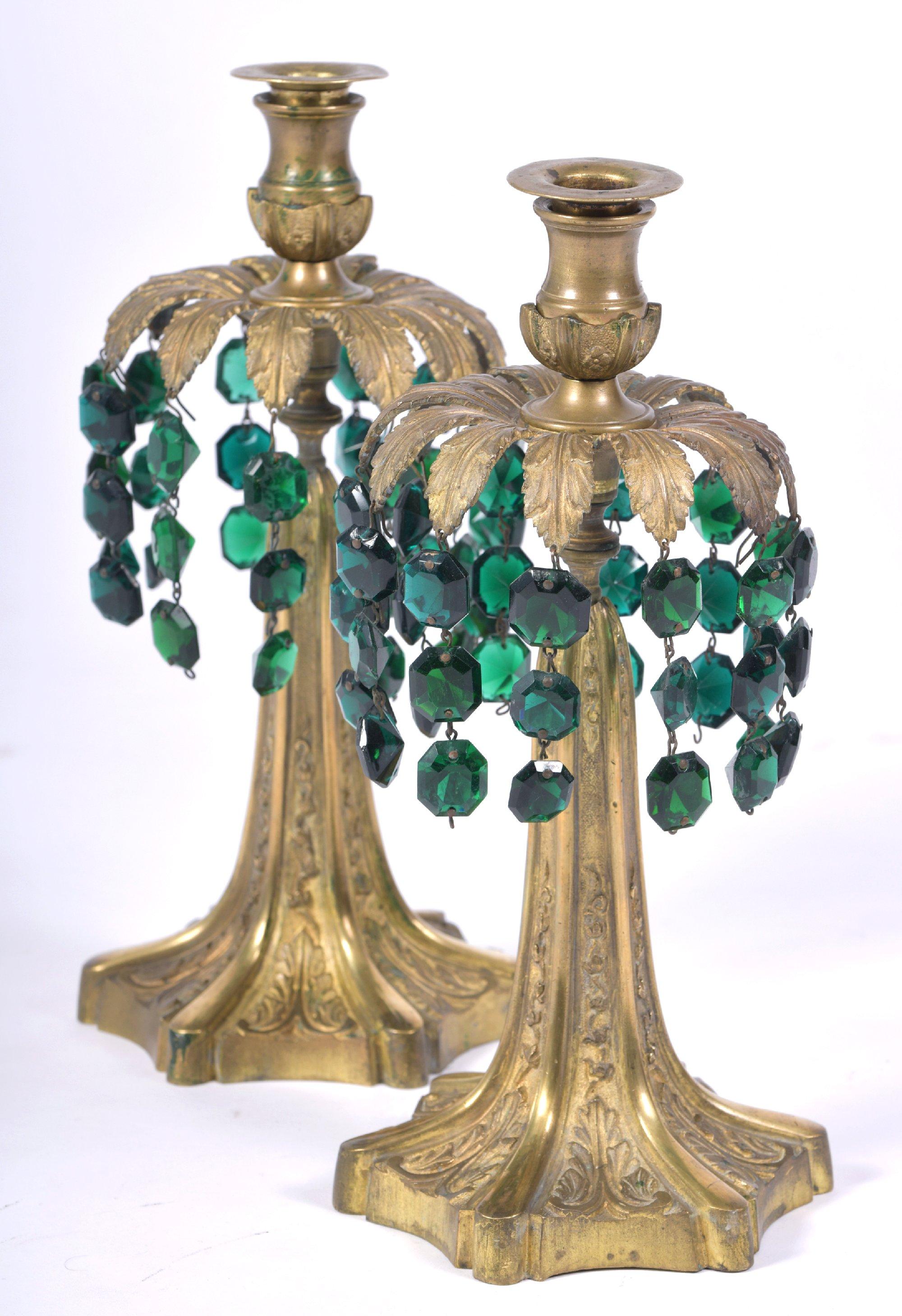 This lovely and very decorative pair of early 20th century brass candlesticks feature a palm tree motif shape with green glass drops hanging from fronds around the top. The candlesticks measure 5 in – 12.3 cm in diameter and 12 in – 30.5 cm in