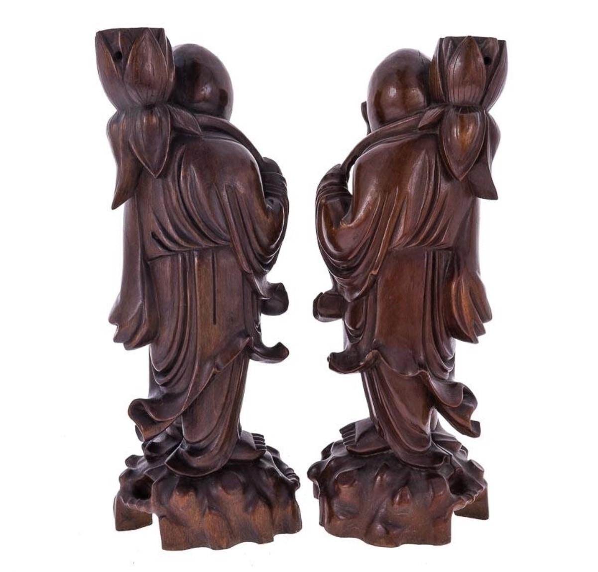Early 20th century set of two hand carved tamarind wood laughing Buddha candleholders.
Measures: Height 15