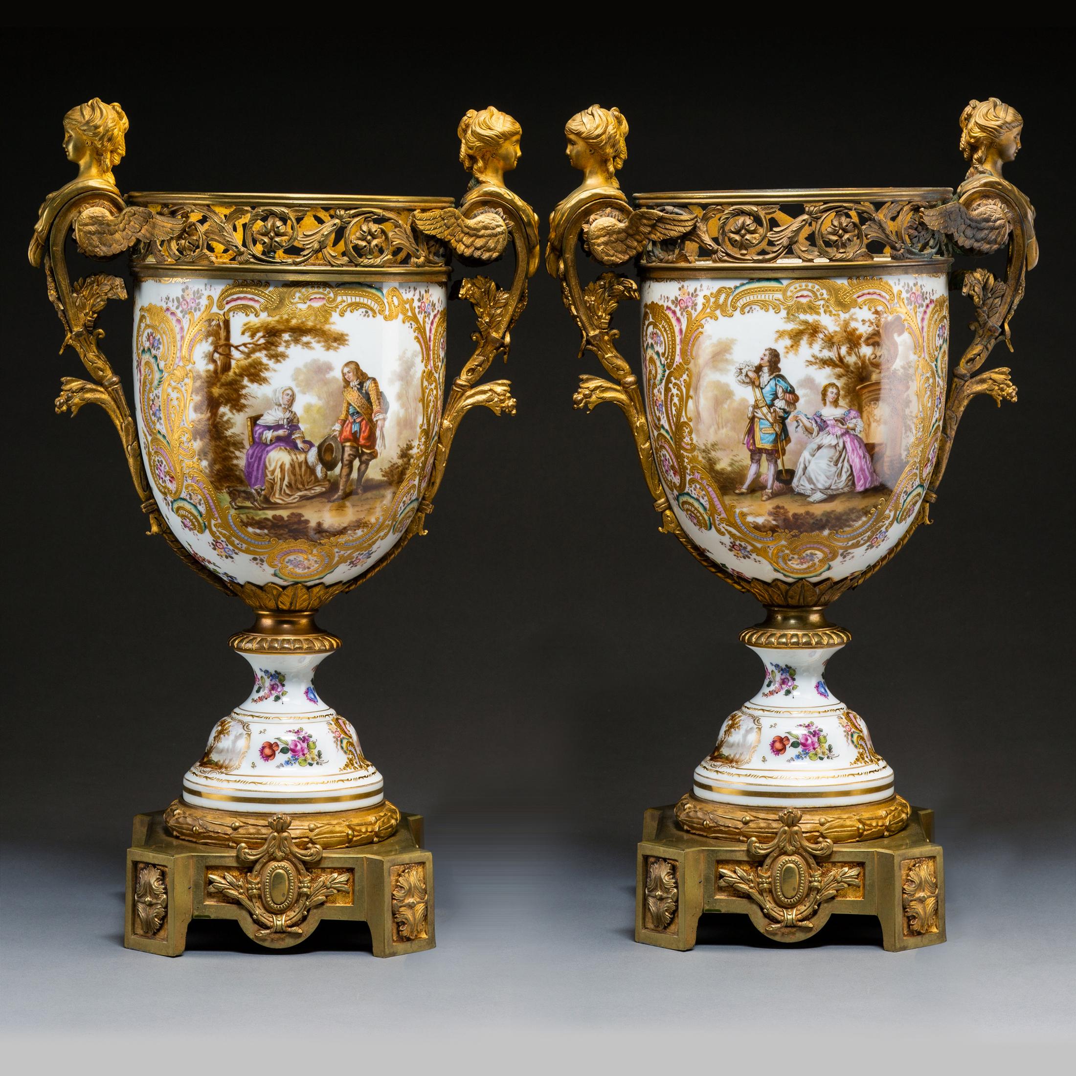 An elegant pair of continental gilt bronze-mounted painted porcelain urns
Origin: French
Date: circa 1900
Mark: Crossed Swords Mark
Dimension: 22 x 14 inches.