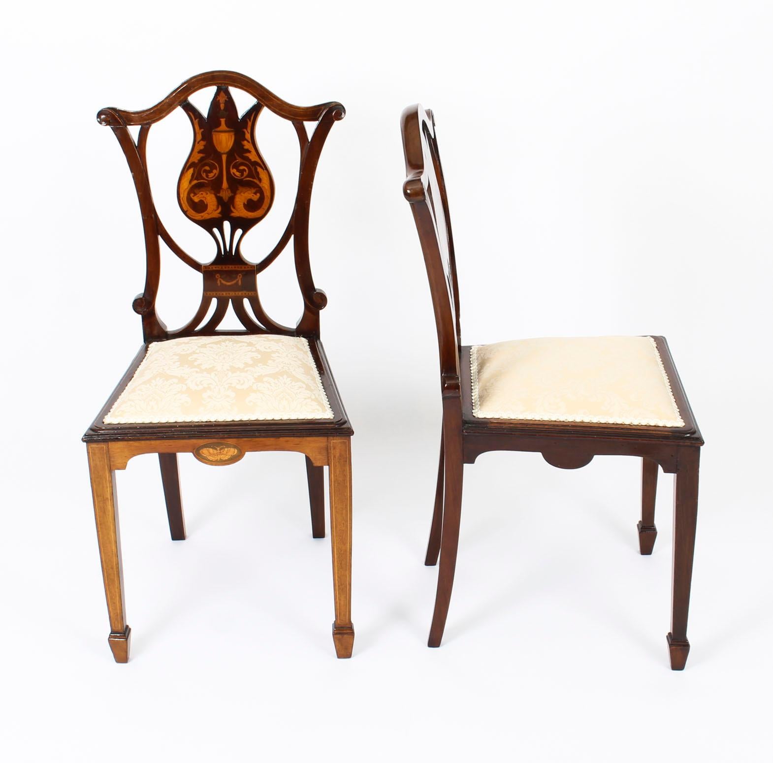 This is a beautiful antique pair of Edwardian mahogany inlaid bedroom chairs, circa 1900 in date.
 
These chairs have been masterfully crafted in beautiful solid mahogany. The cartouche shaped backs are decorated with satinwood marquetry dragons