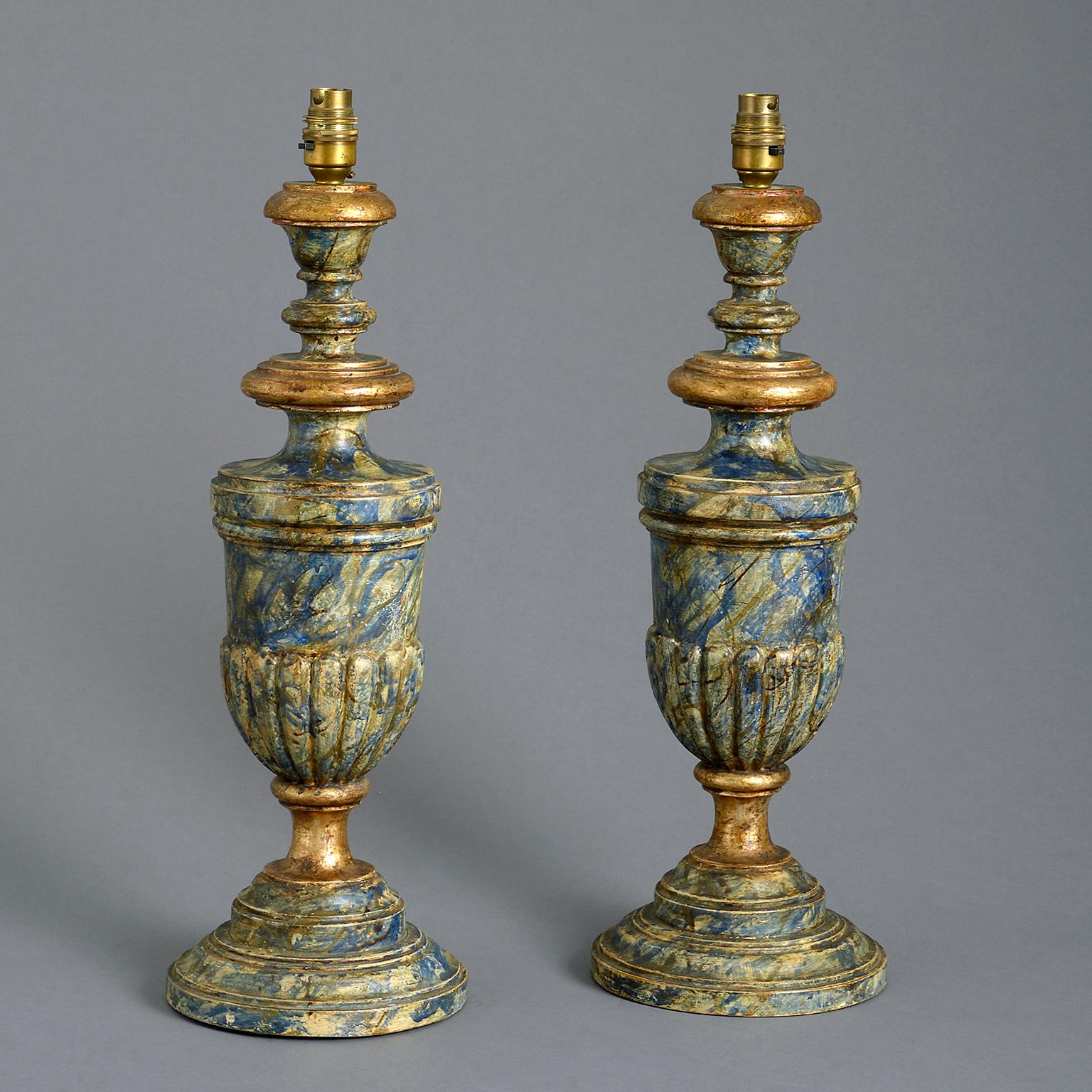 A pair of early 20th century faux marble lamps in the form of elongated campana urns with gadrooned bowls standing on waisted socles and stepped bases; beautifully decorated by hand with a faux marble and gilt surface. Wired with silk-braided flex.
