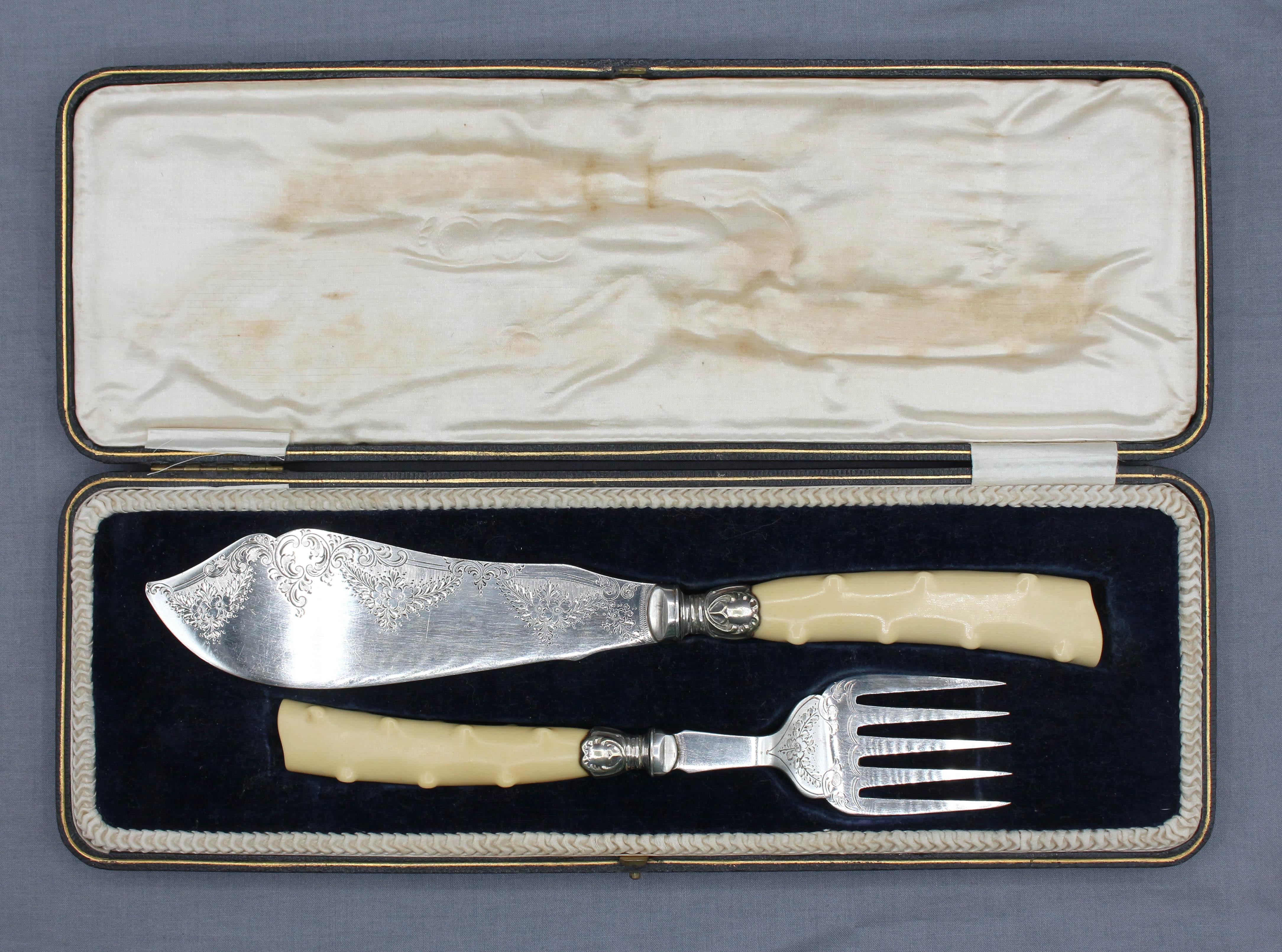 Early 20th century pair of fish servers in original presentation case, English. Engraved silver plate on nickle blade & fork with silver plate ferrules and faux bois molded ivorine handles. By Harrison Fisher & Co, 1900-1925 hallmarks. Elegant