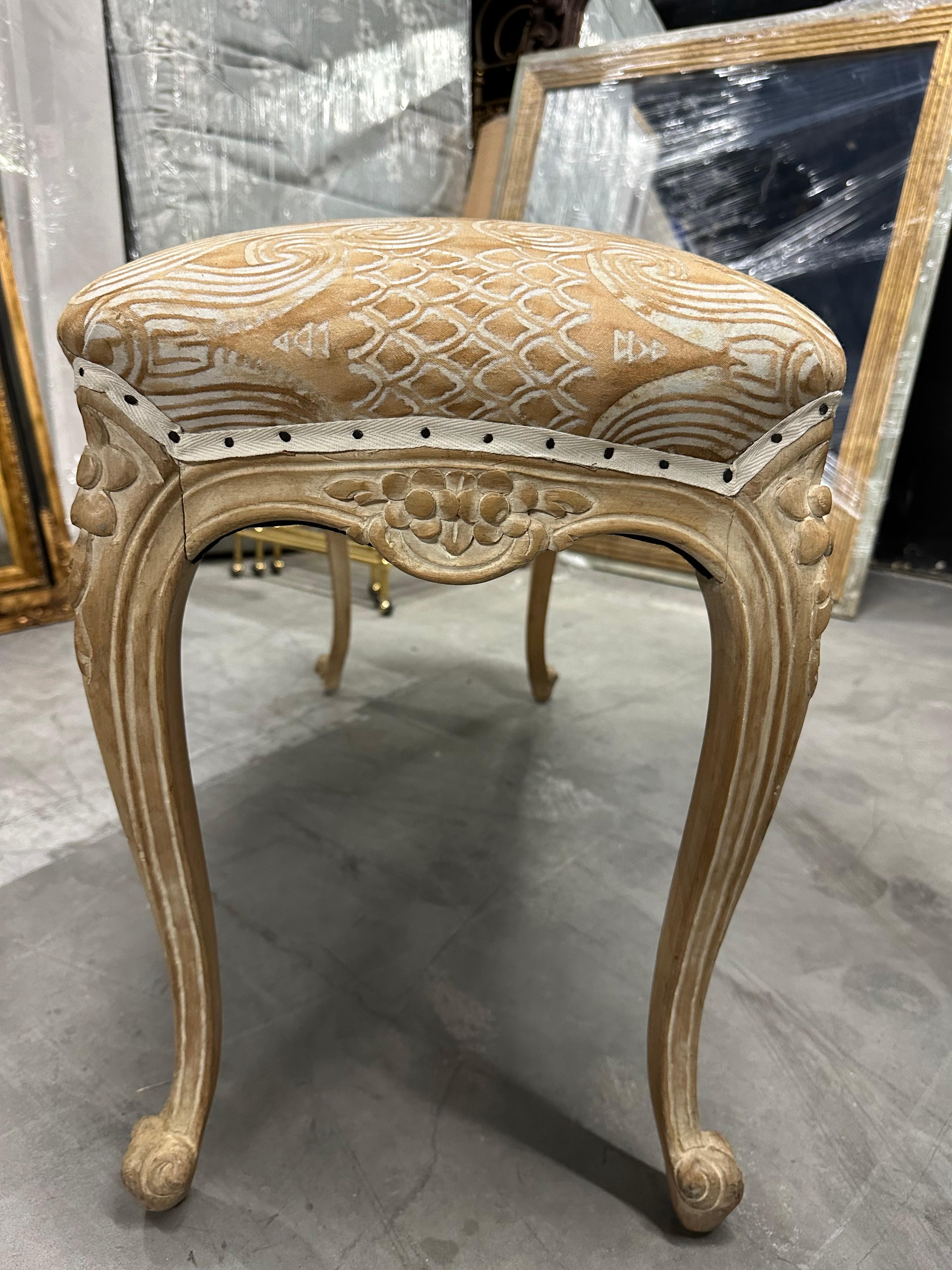 Pair of French Carved Benches With Antique Fortuny Fabric. The legs are beautifully carved.