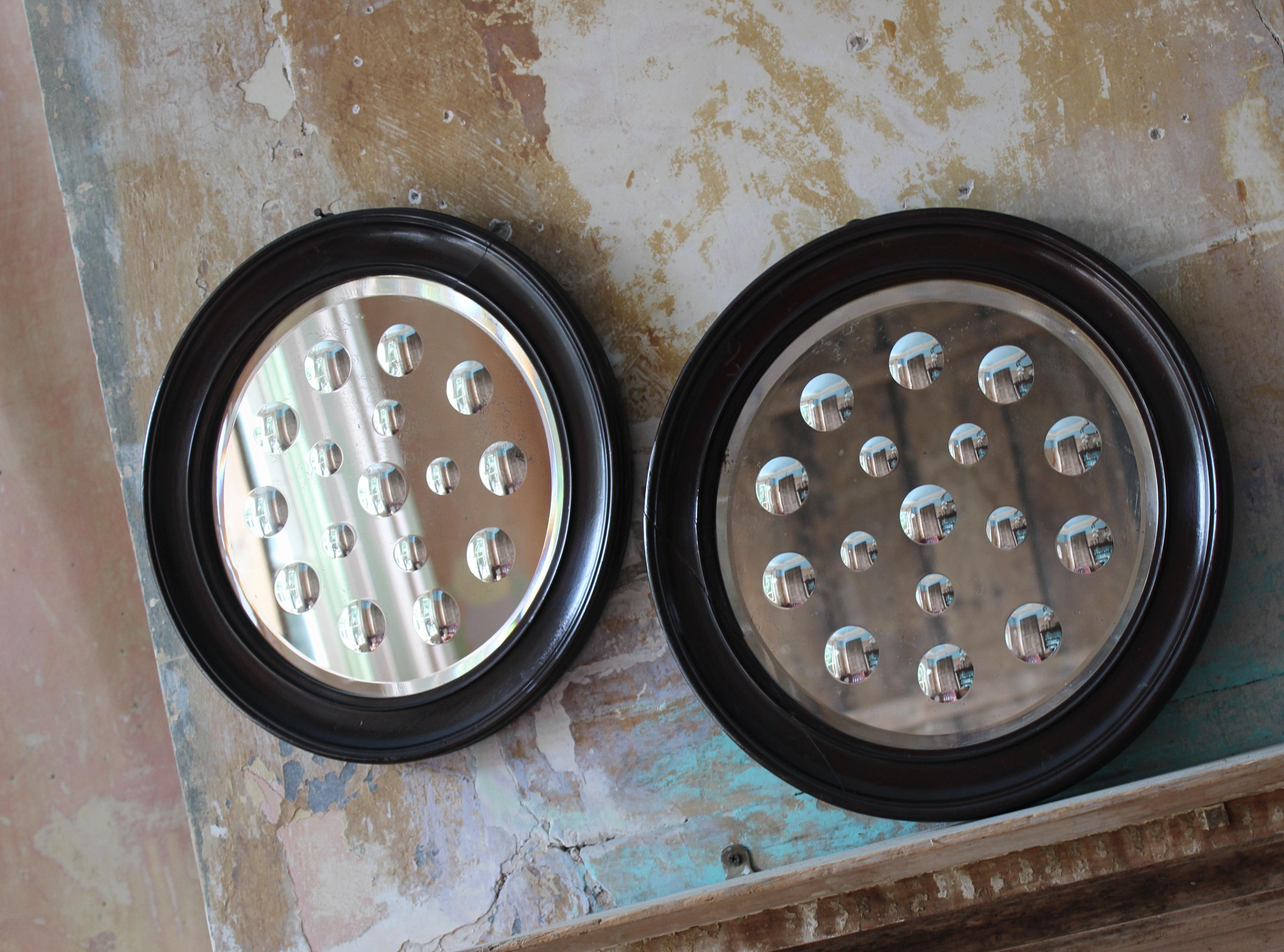 A good sized matching pair or early 20th century sorcerers mirrors with 11 large reverse ground optics and 5 smaller.

Housed in there original mahogany frames, some elderly spilts well repaired. Minor foxing to the mirror plates

38cm in diameter