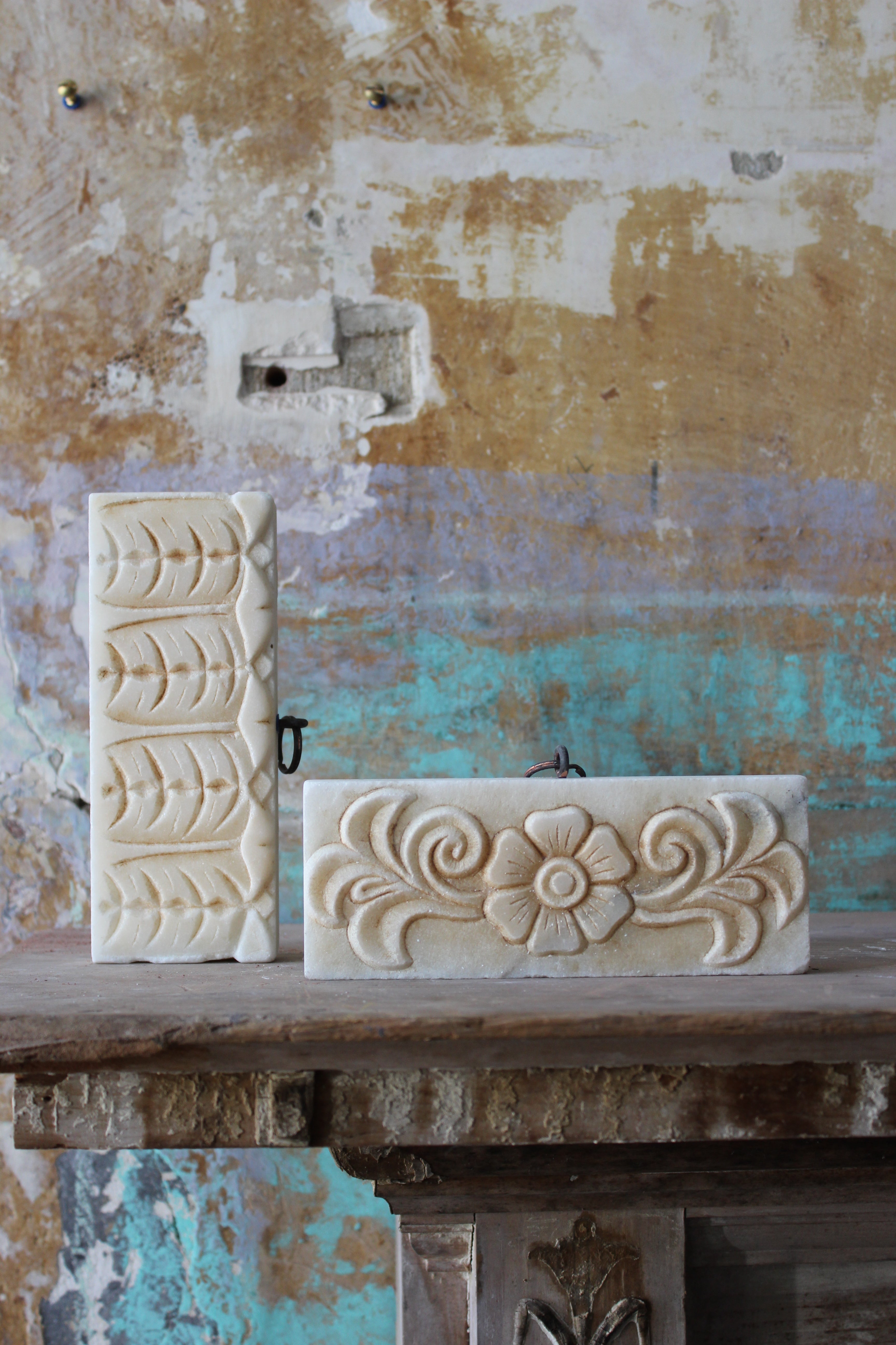 Early 20th century carved decorative tablets, previously part of a larger architectural feature or fireplace. One with a floral organic relief and the other a continues pattern. 

The sections are well carved, crisp and has a good decorative patina,