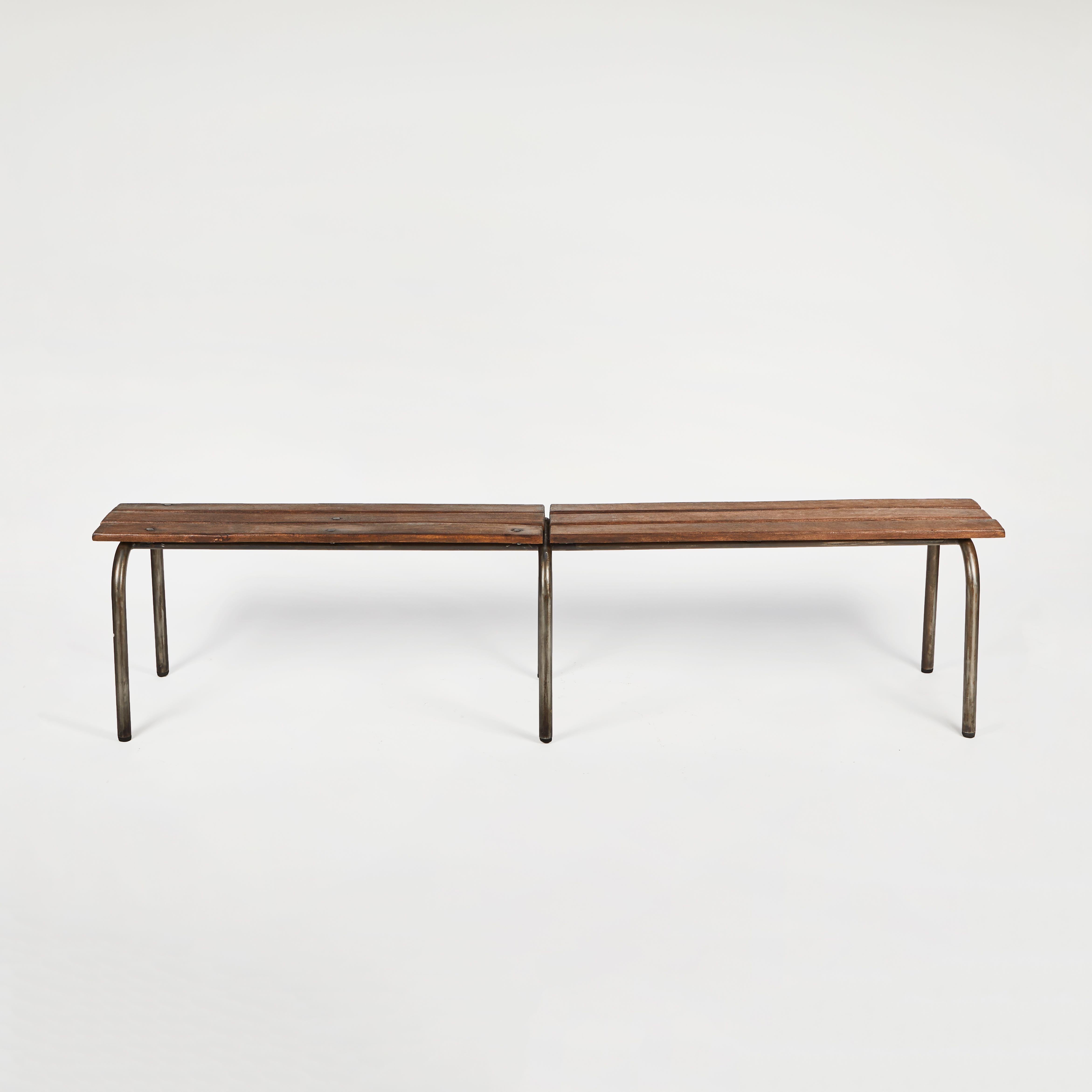 Early 20th-century French modernist metal and wood bench France. The seat is comprised of three tawny wood planks and is supported by three evenly spaced bent metal legs. Chic and industrial, the top appears to almost be floating in space.  Also