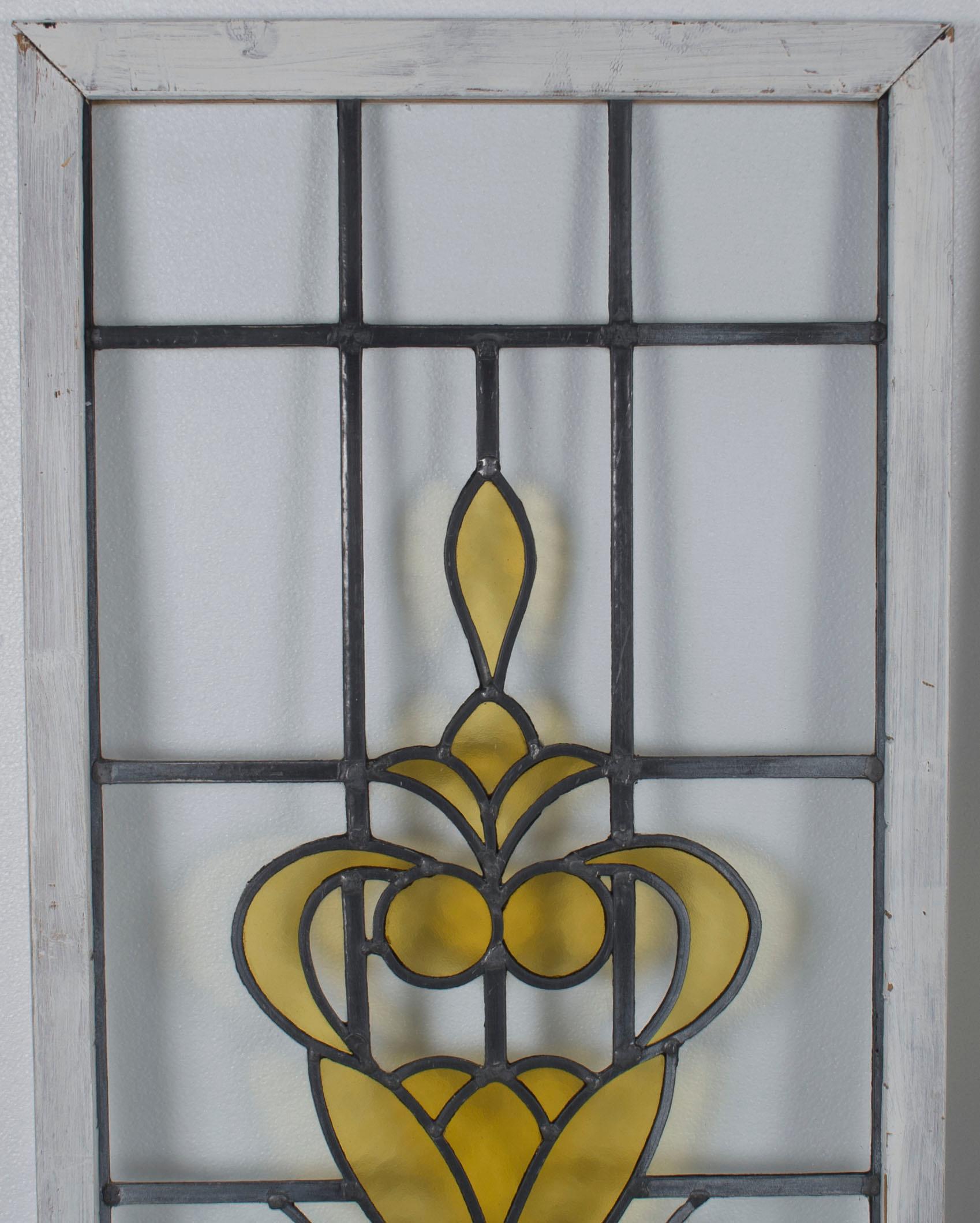 Here we have a pair of leaded stained glass panels. One panel is slightly larger than the other, but both have identical yellow glass patterns. These come from England and were made sometime in the early 20th century. The old, wavy glass is quite
