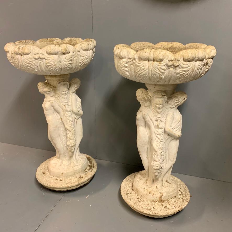 Impressive pair of composite stone garden urns with great detail to the scrolling leaf bowls and supported by figure columns and good solid plinth bases.
Both have been white washed and are nicely weathered, but I know these had been used for