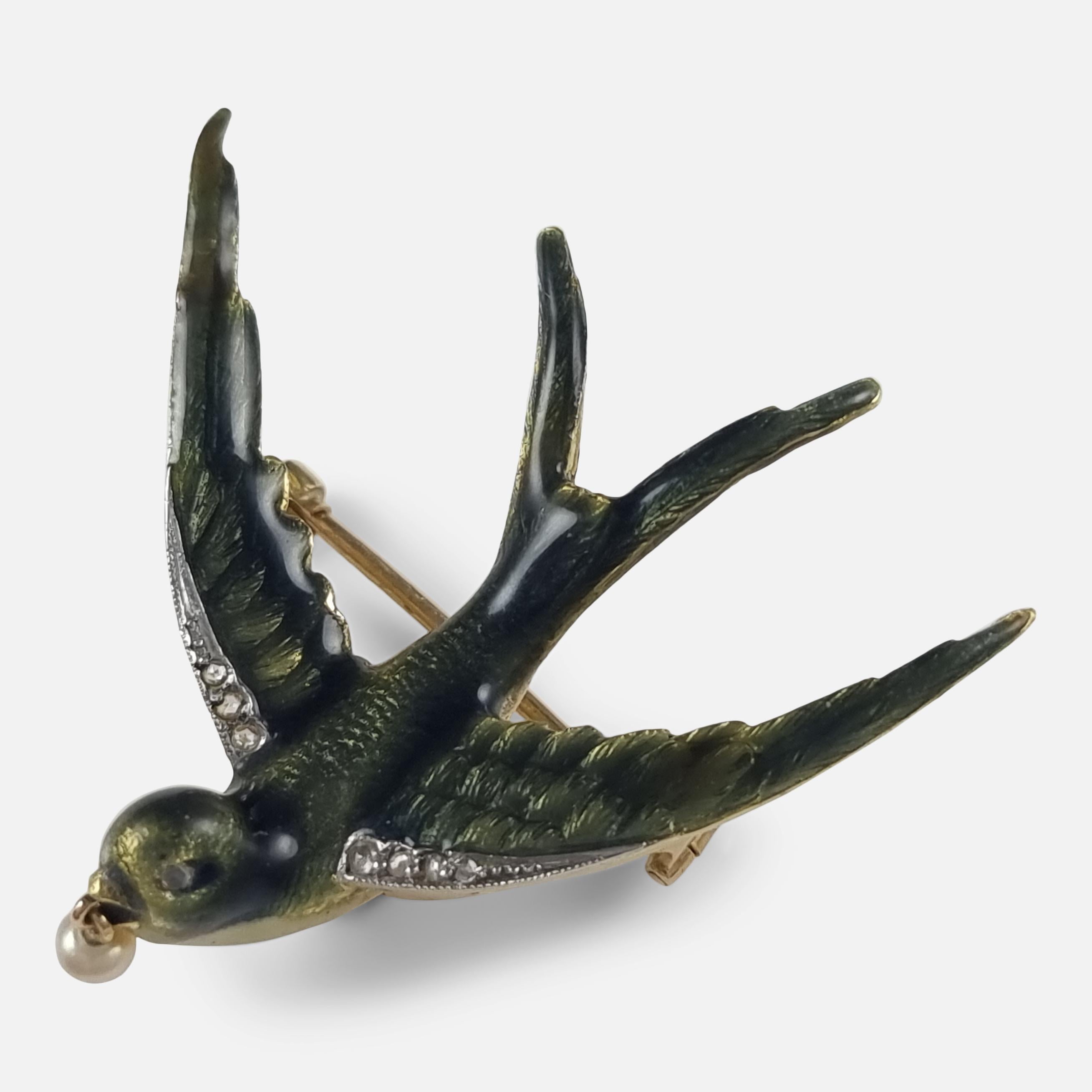 An early 20th century swallow brooch. The brooch is in the form of a swallow, with realistically engraved feathers, green enamel decoration, wings and eye set with rose-cut diamonds, and holding a small pearl in its beak. During the 19th and early
