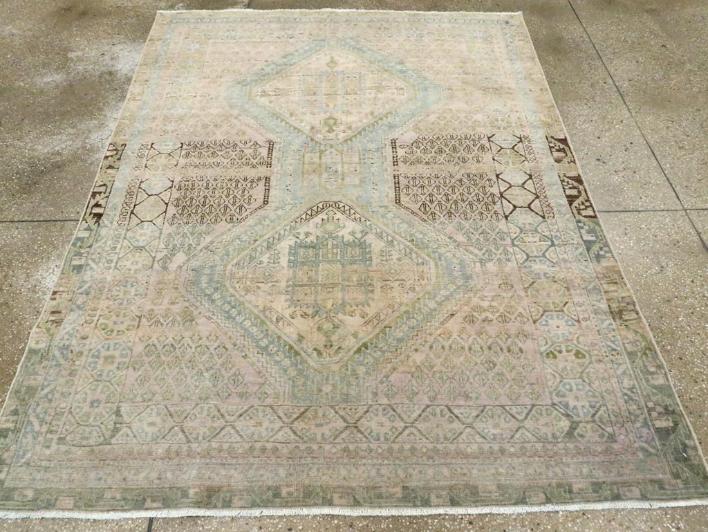 A Symmetric wool knots on a cotton foundation. This firmly woven tribal scatter shows significant abrash in the reds and browns, but surprisingly, the light blue remains unaffected. The classic two-diamond pattern features sawtooth outlines, with a
