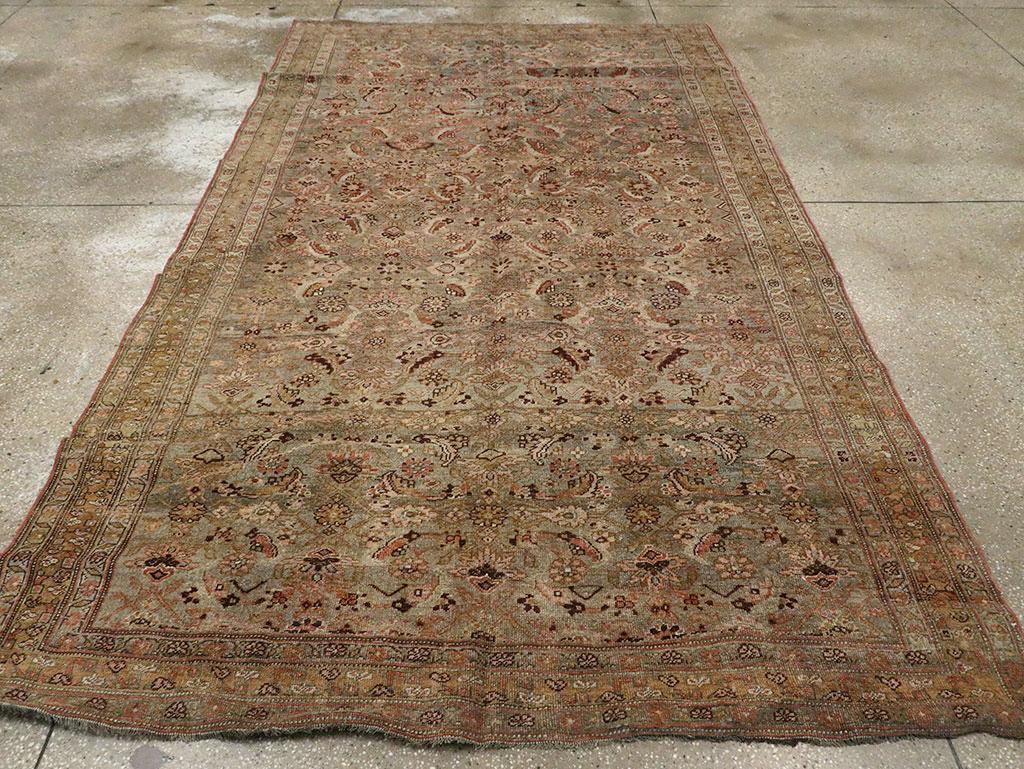 An antique Persian Bidjar accent carpet. The abrashed greyish ground supports an allover classically rendered Herati design with black accents, set within a rust border of stylized leaves and flowers. This Kurdish accent carpet is very well woven,