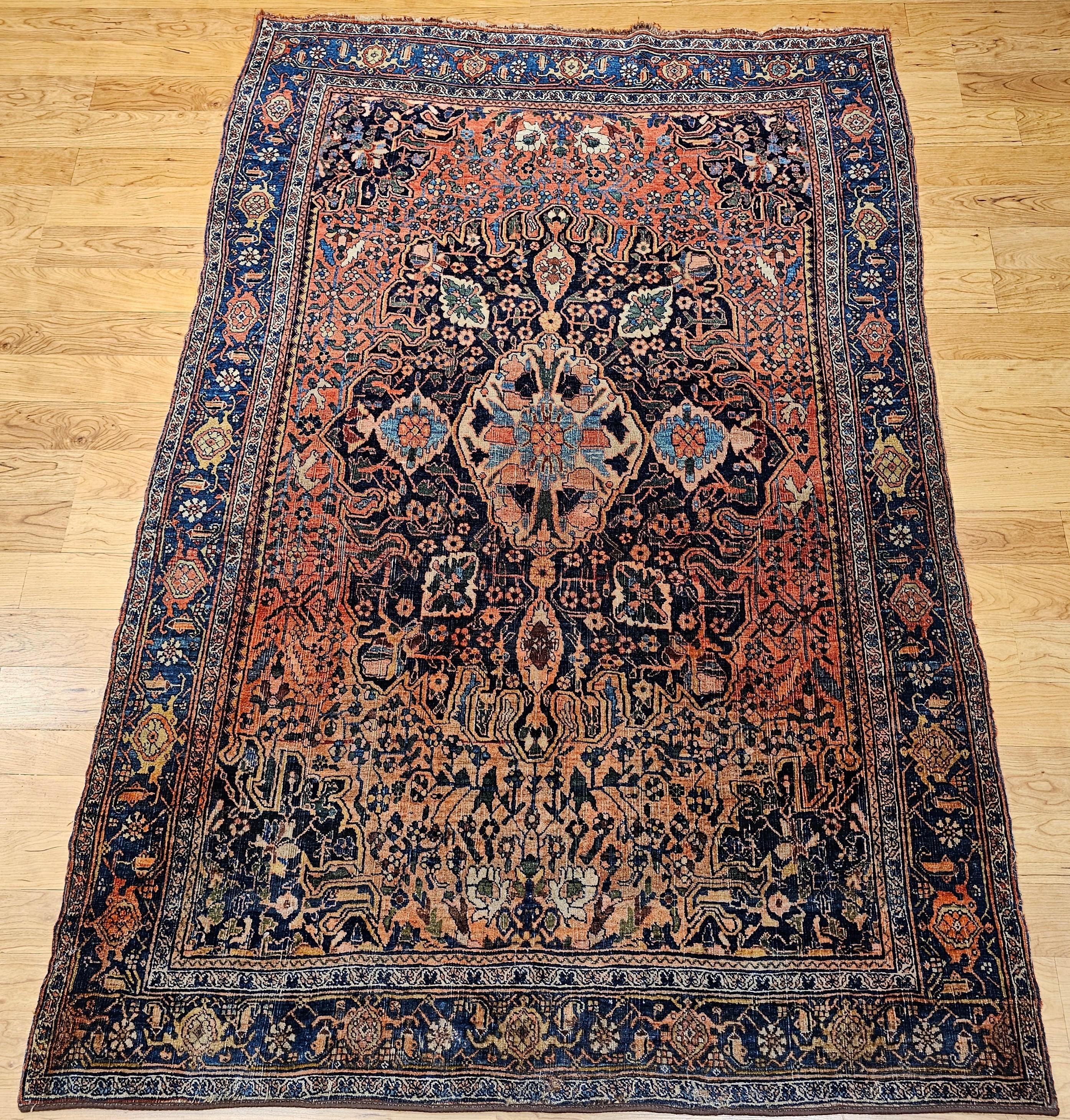 Early 20th century Persian Bidjar area rug with a medallion design in a floral geometric pattern in red, French blue, and navy blue, green, yellow colors.   The rug has a combination of an abrash French blue and rich red field colors.    The Bidjar