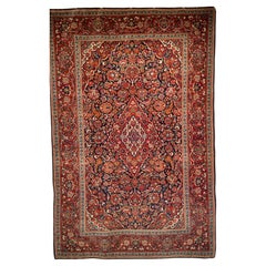 Antique Early 20th Century Persian Kashan Area Rug in Floral Design in Navy, Red, Blue