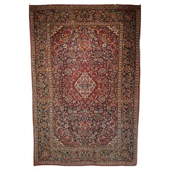 Antique Early 20th Century Persian Kashan Area Rug in Floral Design in Navy, Red, Blue