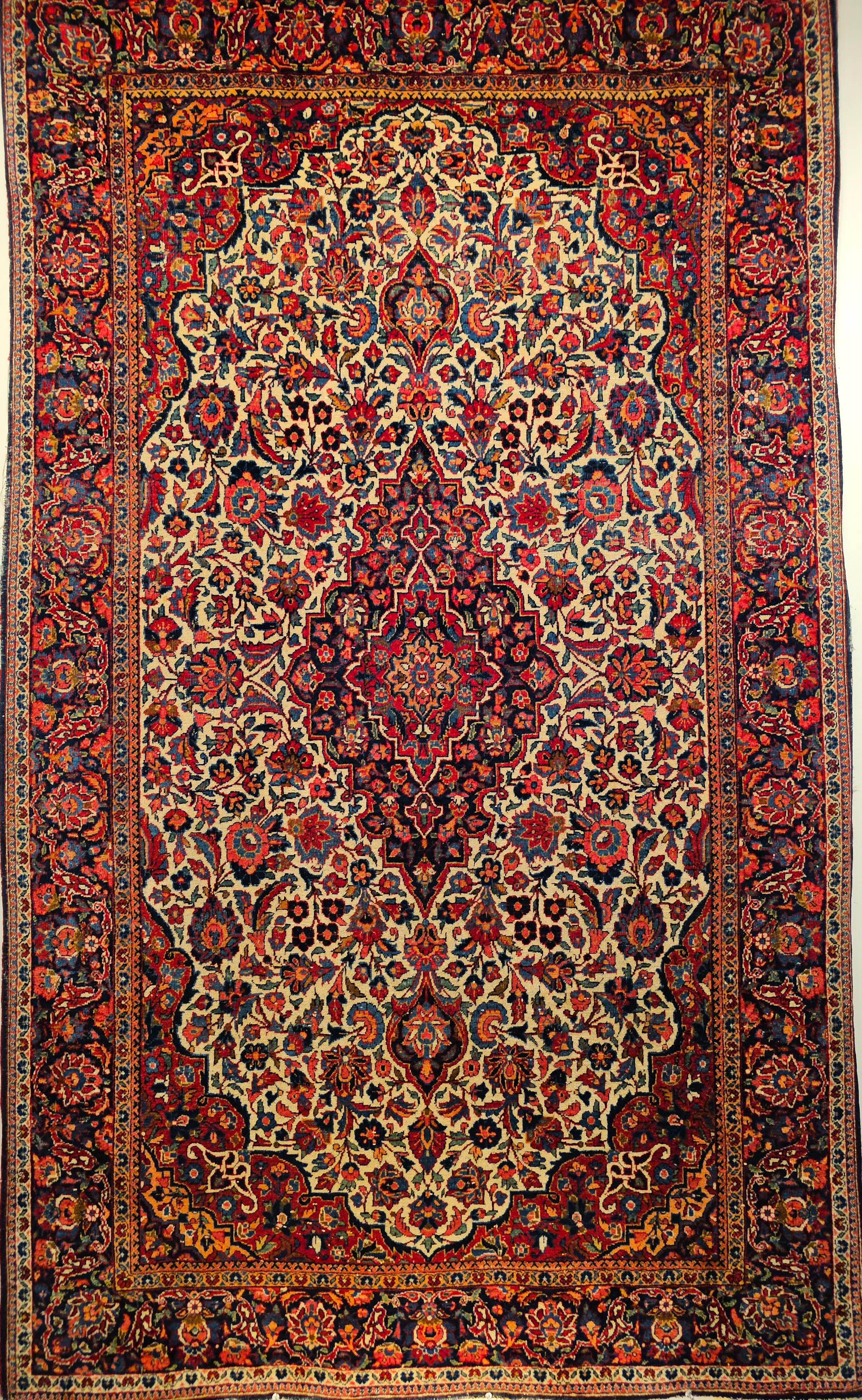 An early 1900s hand-woven persian Kashan floral design area rug in a rare ivory color background.   The classical design and luminous, resilient wool quality of this outstanding vintage Persian Kashan carpet create an impression of consummate