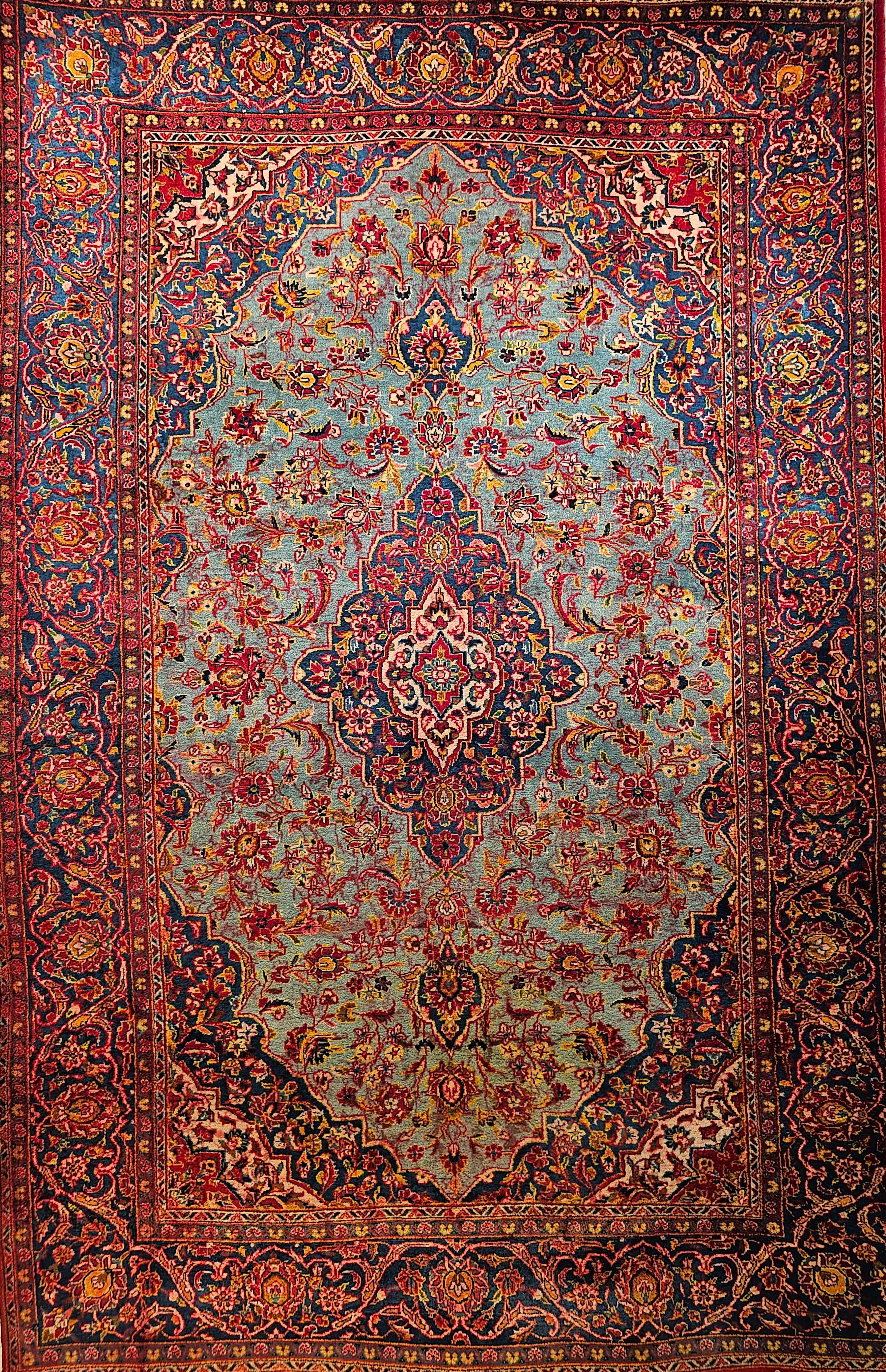 An early 20th century  hand-woven Persian Kashan floral design area rug in a rare turquoise color background.   The classical design and luminous, resilient wool quality of this outstanding vintage Persian Kashan carpet create an impression of
