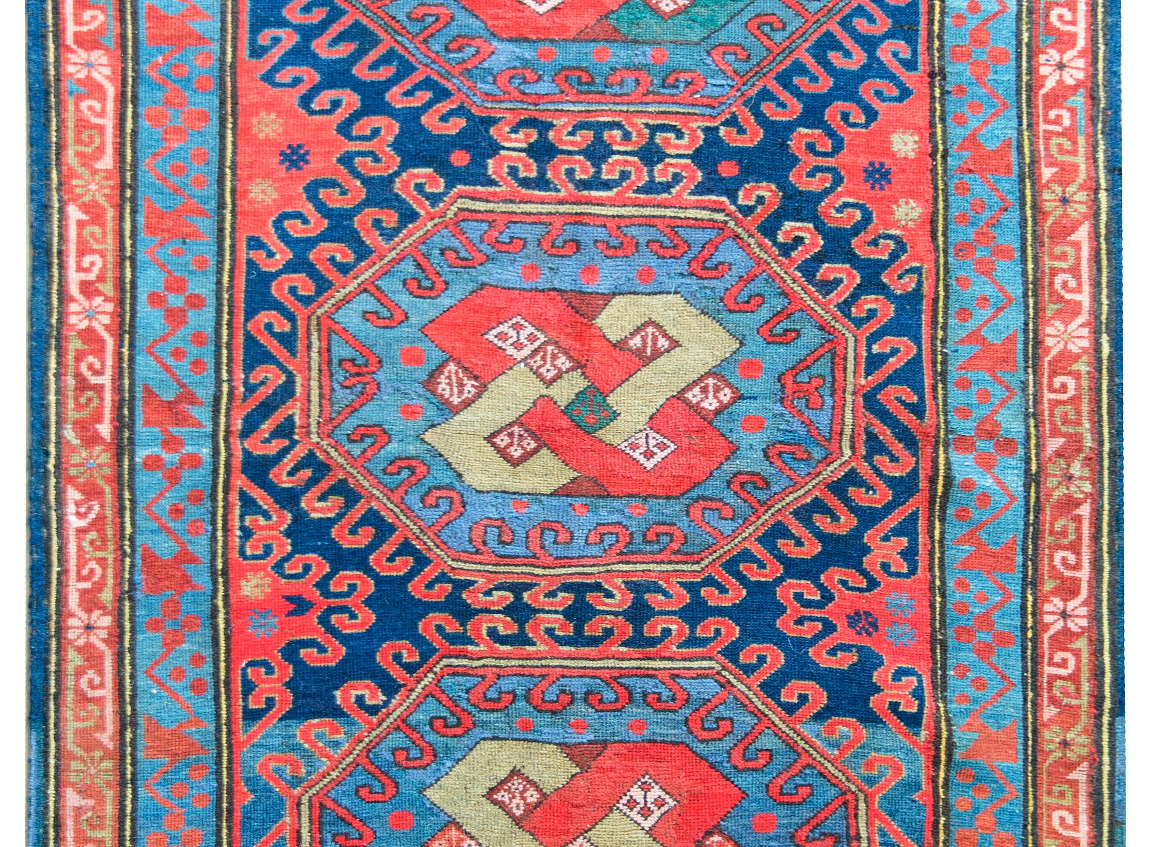An incredible early 20th century Persian Kazak rug with three central medallions each with an endless knot pattern surrounded by stylized floral patterns, and all surrounded by a complex border with two floral patterned stripes, and all woven in