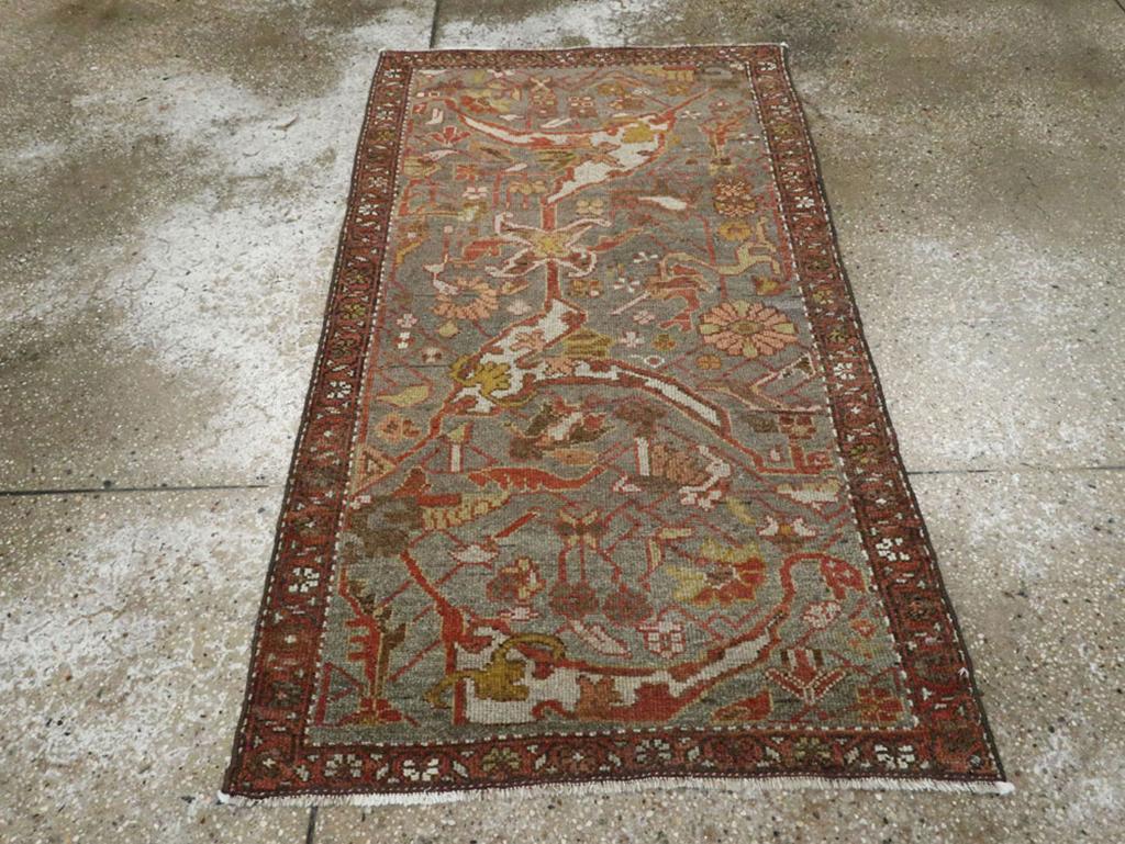 An antique Persian Kurdish throw rug. The graphite ground displays gigantic ivory forked arabesque elements detailed in sienna brown, rust and camel. Rosettes and smaller flowers fill in around the extra-bold main motives on this west Persian