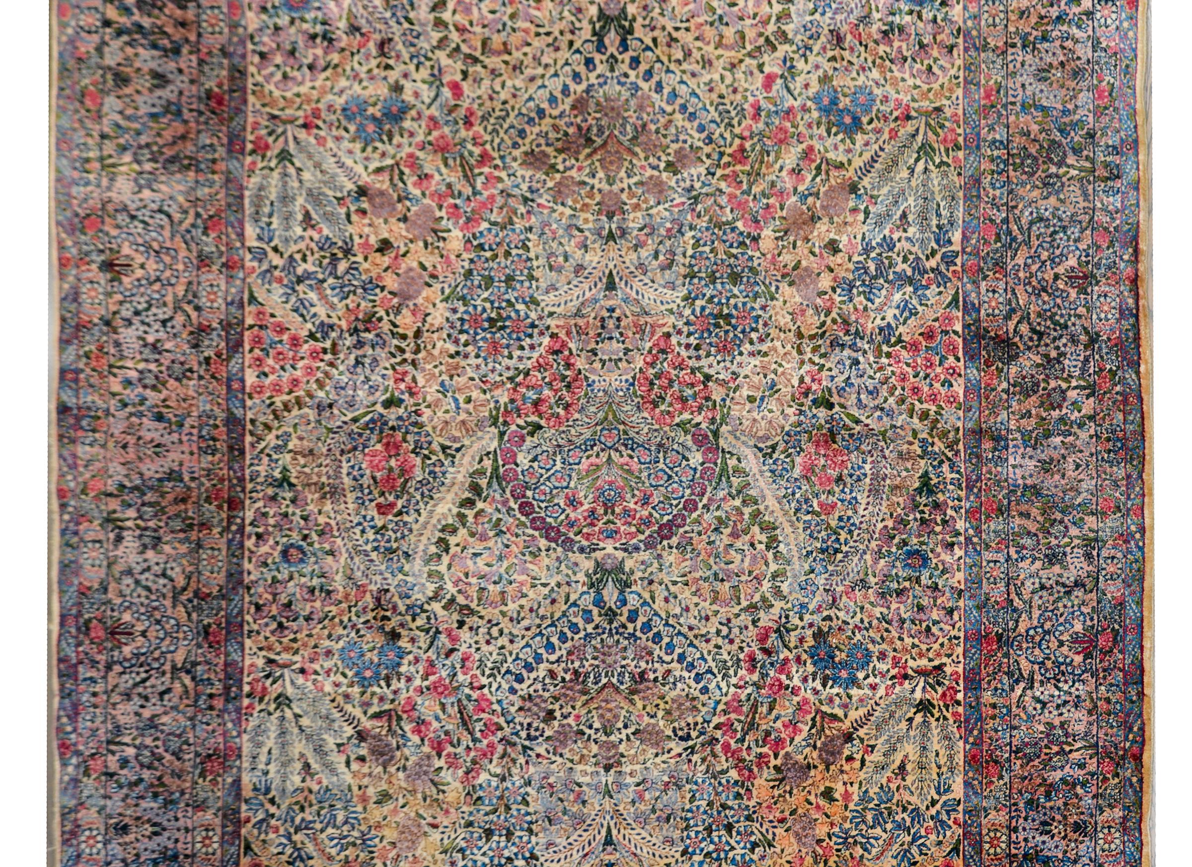 One of the best early 20th century Persian Lavar Kirman rugs we've ever seen! The patten is extraordinary with an all-over floral cluster pattern woven in traditional Kirman colors of pinks, reds, light and dark indigos, creams, and greens, and all