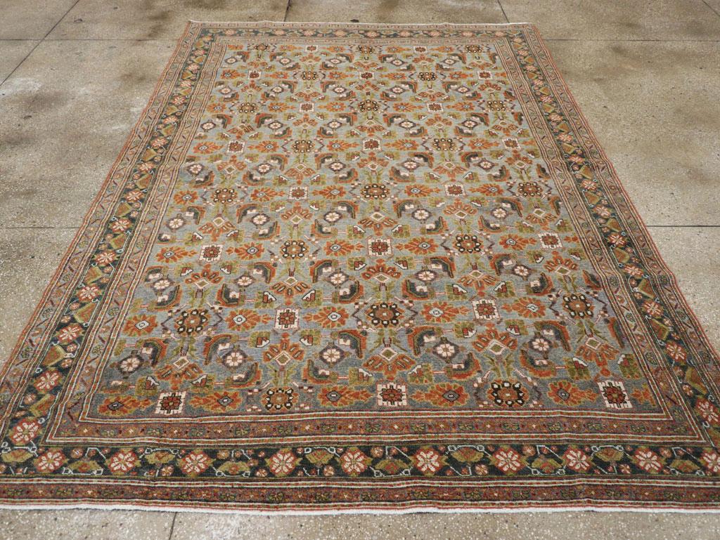 A wool pile of symmetric knots on a cotton foundation. The light pearl/pale blue ground shows an interesting variant on the classic Herati pattern, with boxed and regular rosettes, color segmented open diamonds and sharply bent leaves. Everything