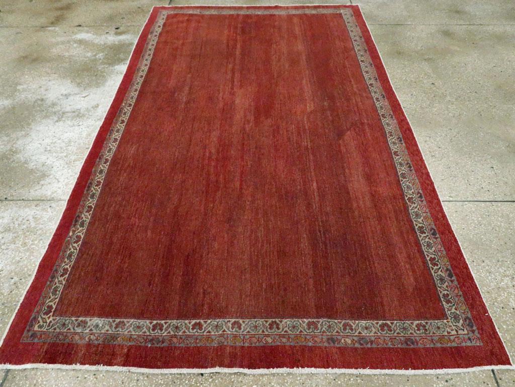 The totally plain brownish-red field is framed by an ecru stripe with reversing fan palmettes and an outer minor with a boteh chain. Moderate weave, cotton foundation. Light, even visible wear.

Measures: 5' 3